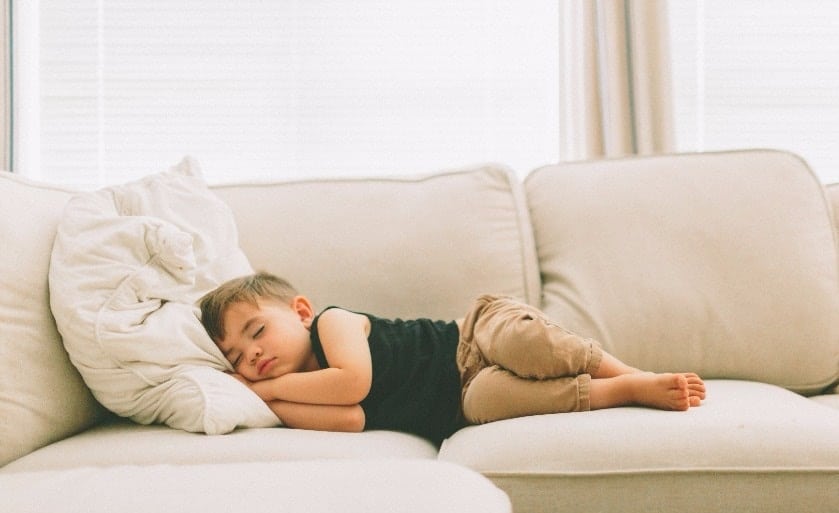 little boy sleeping on the couch