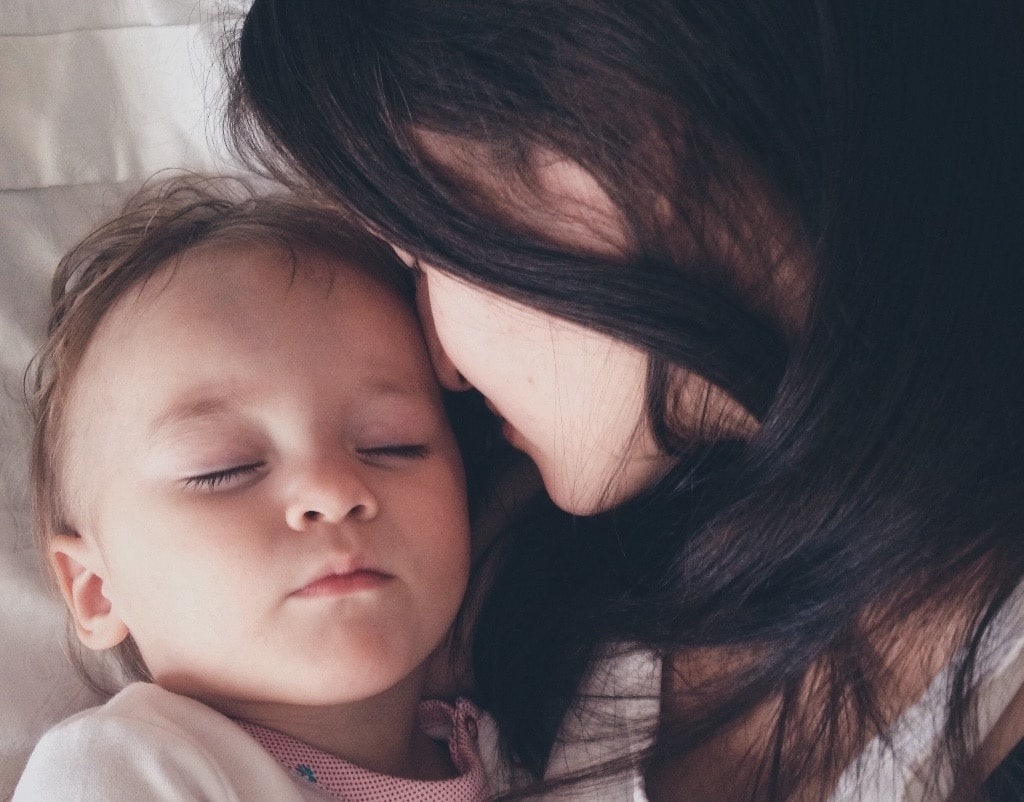 mom watching baby fall asleep