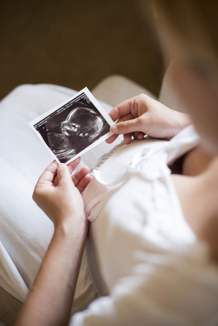 woman looking at an ultrasound picture