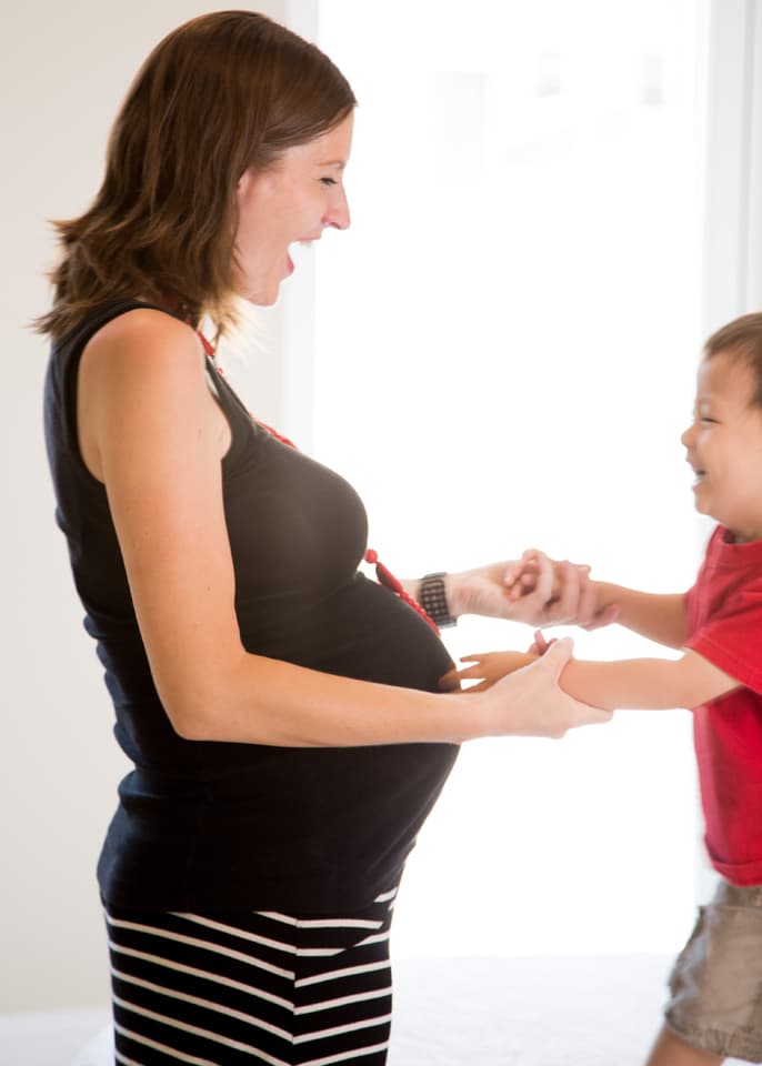 maternity style: pregnant mother dancing with toddler