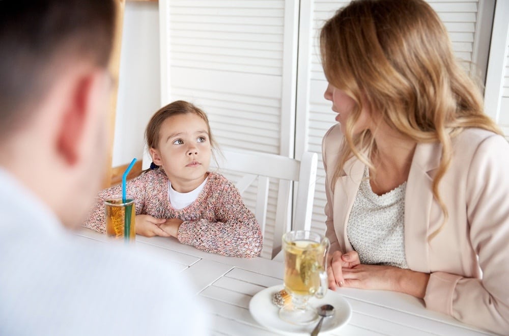 mom talking with toddler at the table