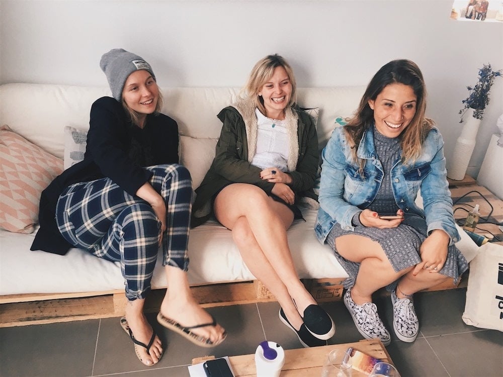 friends sitting on a couch and laughing