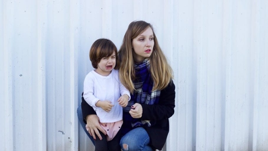 mom holding a crying toddler