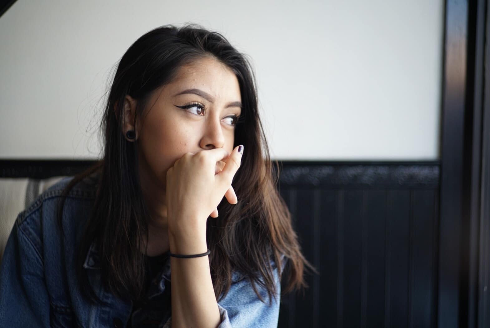 woman with hand over her mouth