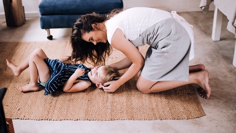 mom playing with child on the floor