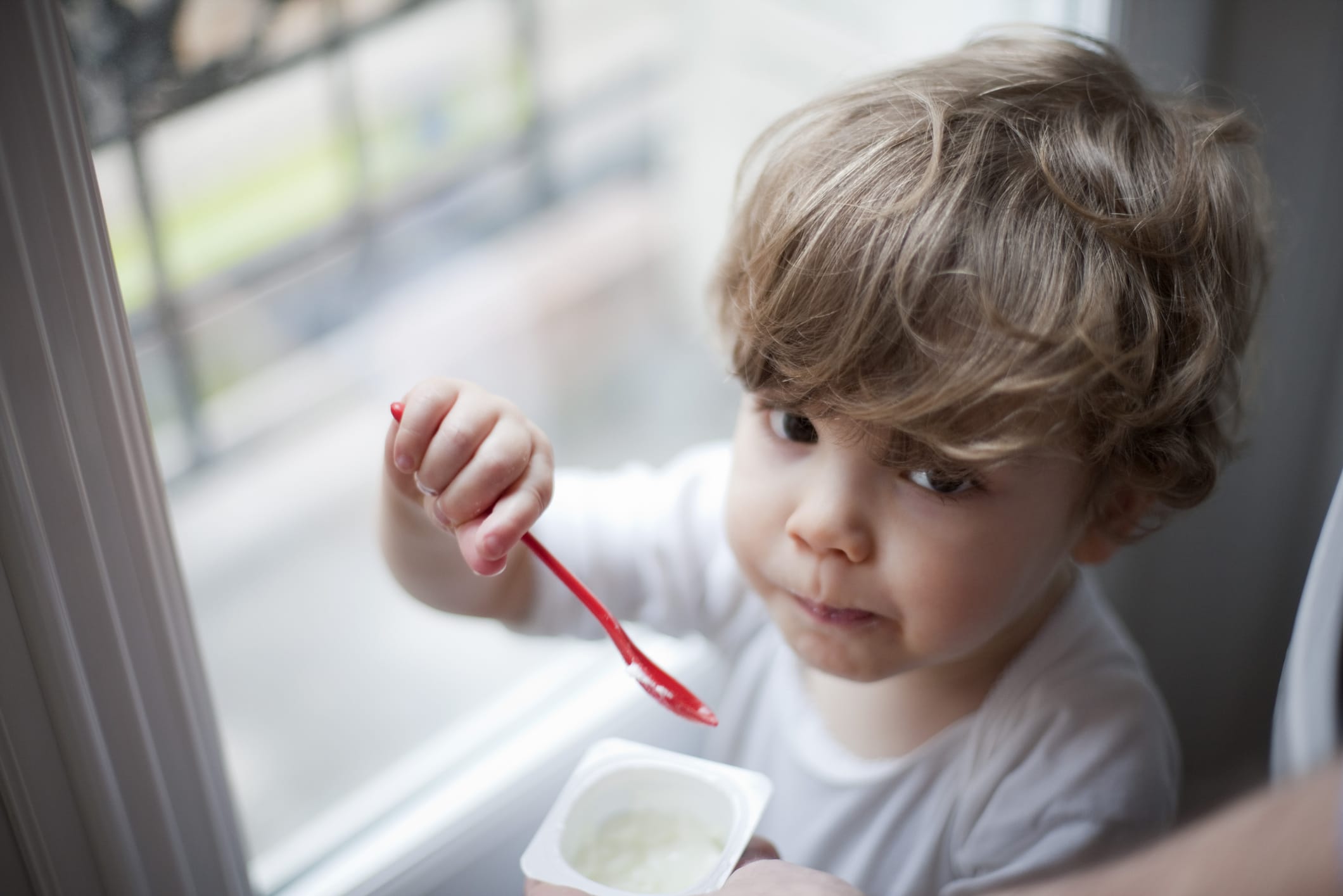 little boy eating yogurt