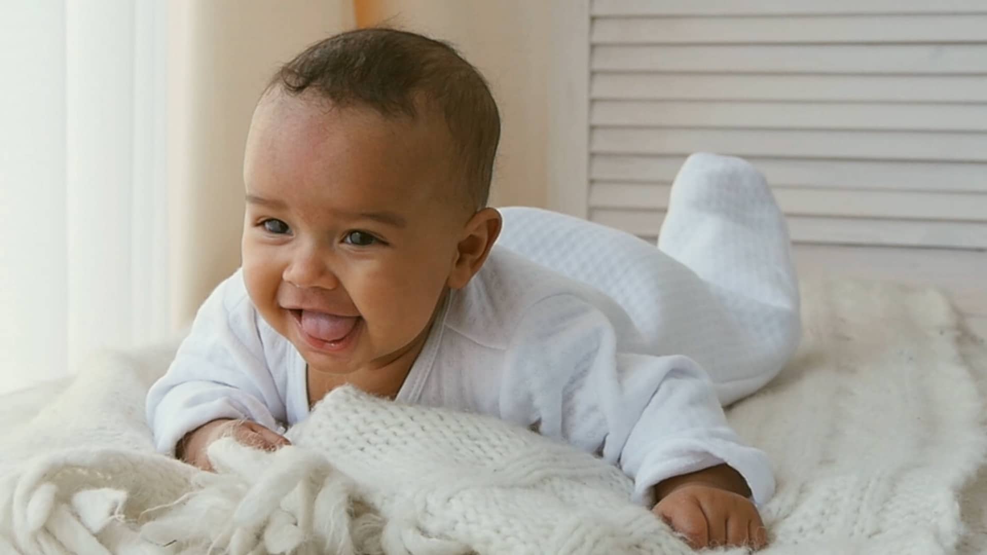 baby doing tummy time on a bed