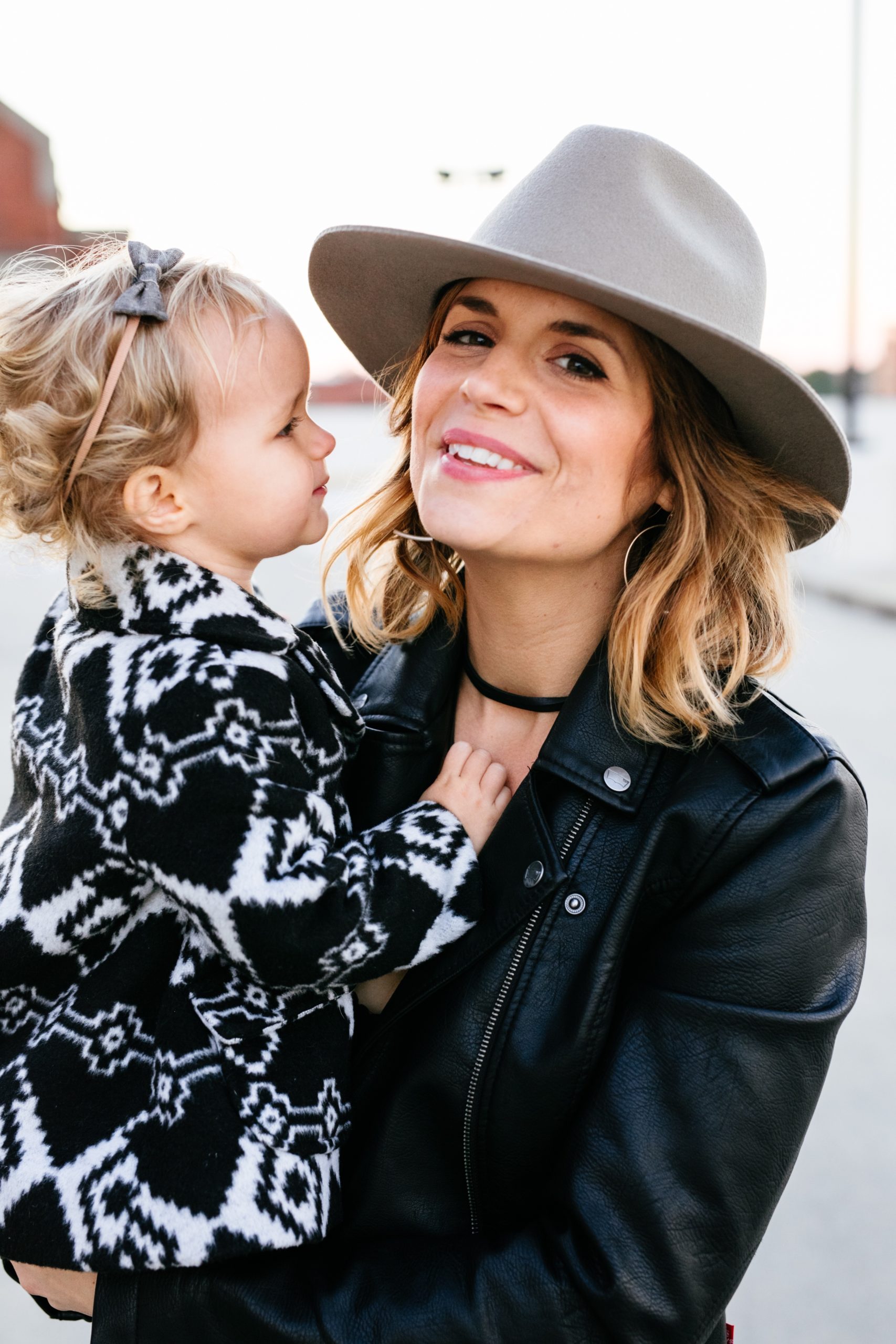 mom holding daughter