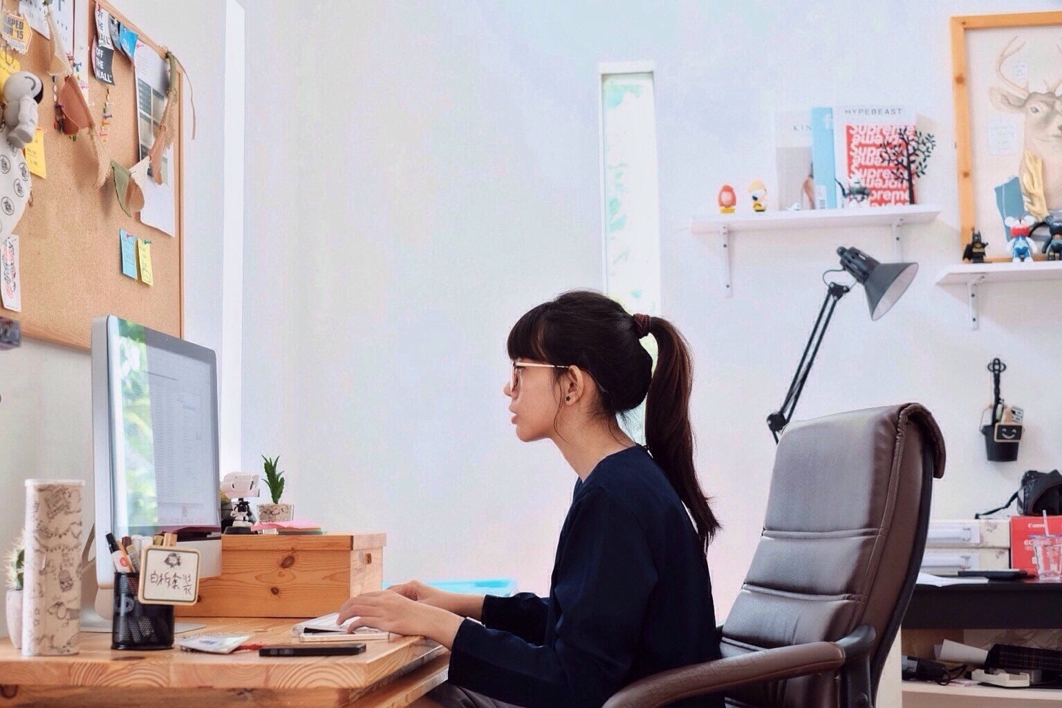 Woman sitting at desk on computer