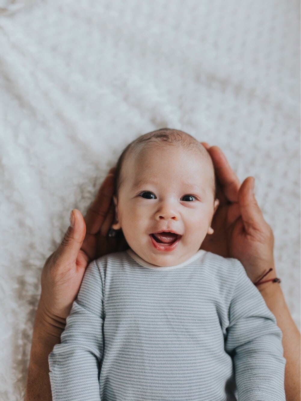 mom holding baby's head in her hands- leo names