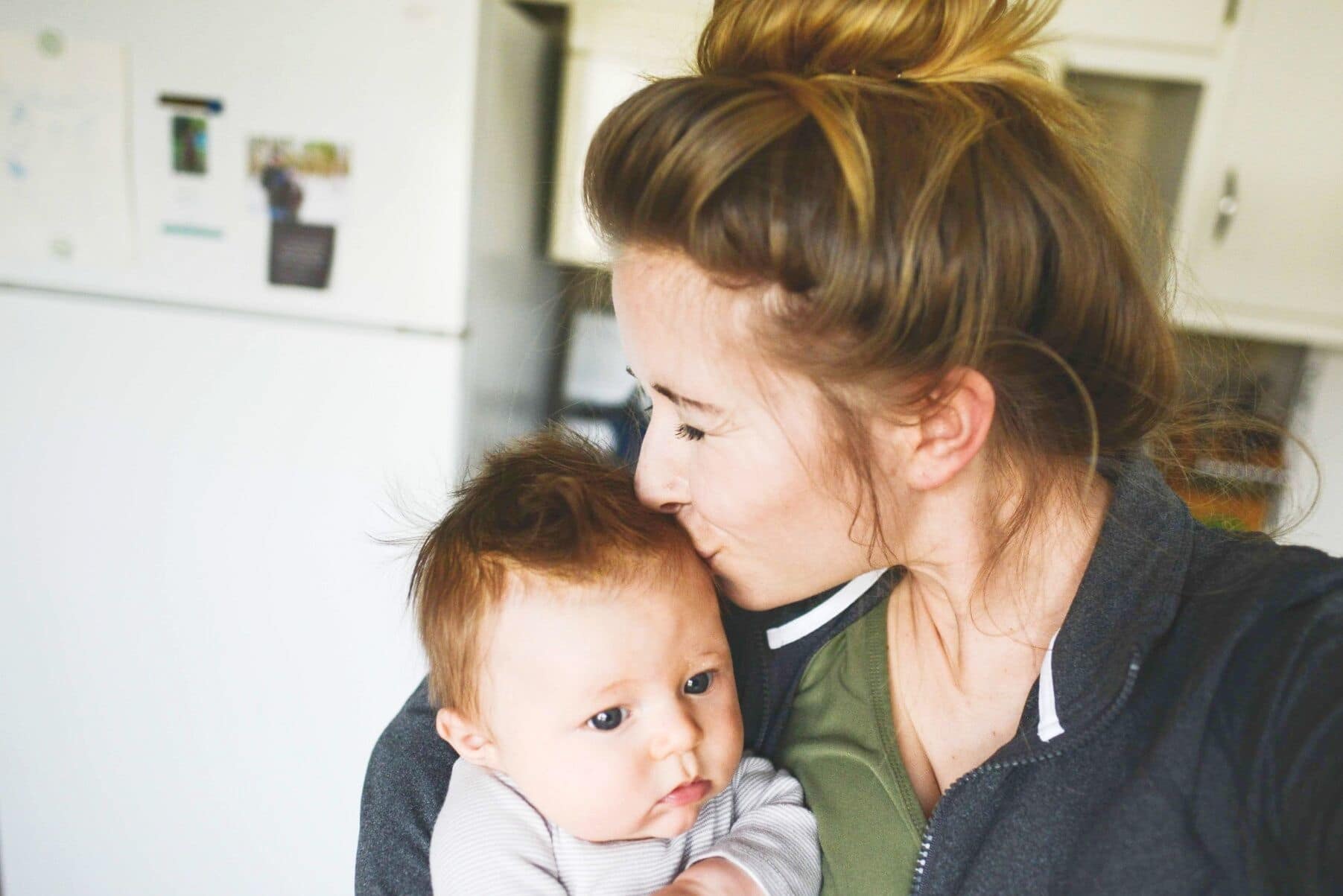 mom kissing her child on the head- my baby is growing up so fast