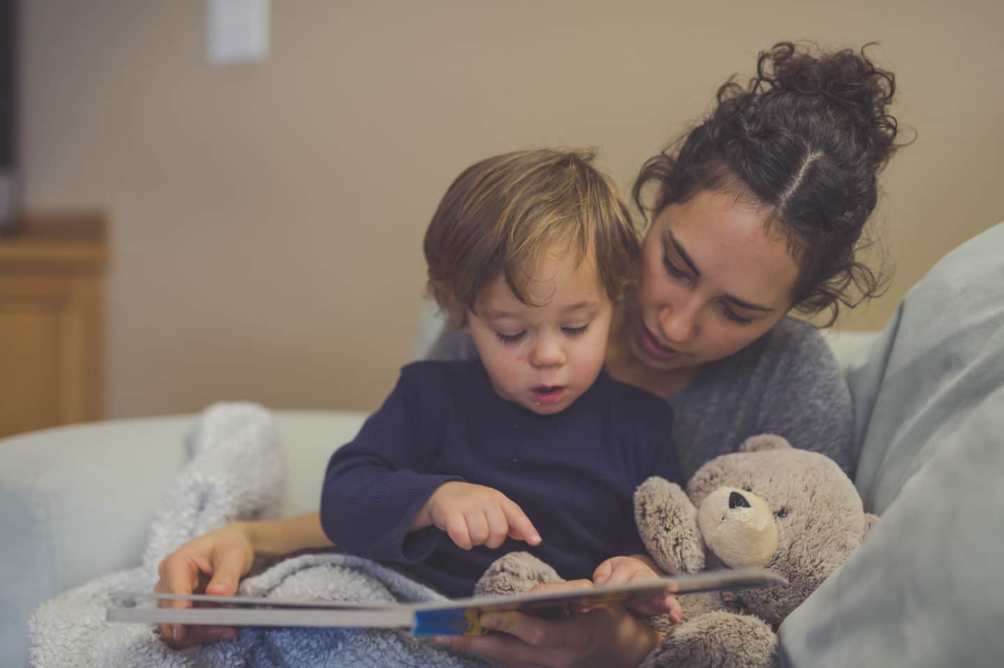 mom reading a book to a child - latinx children's books