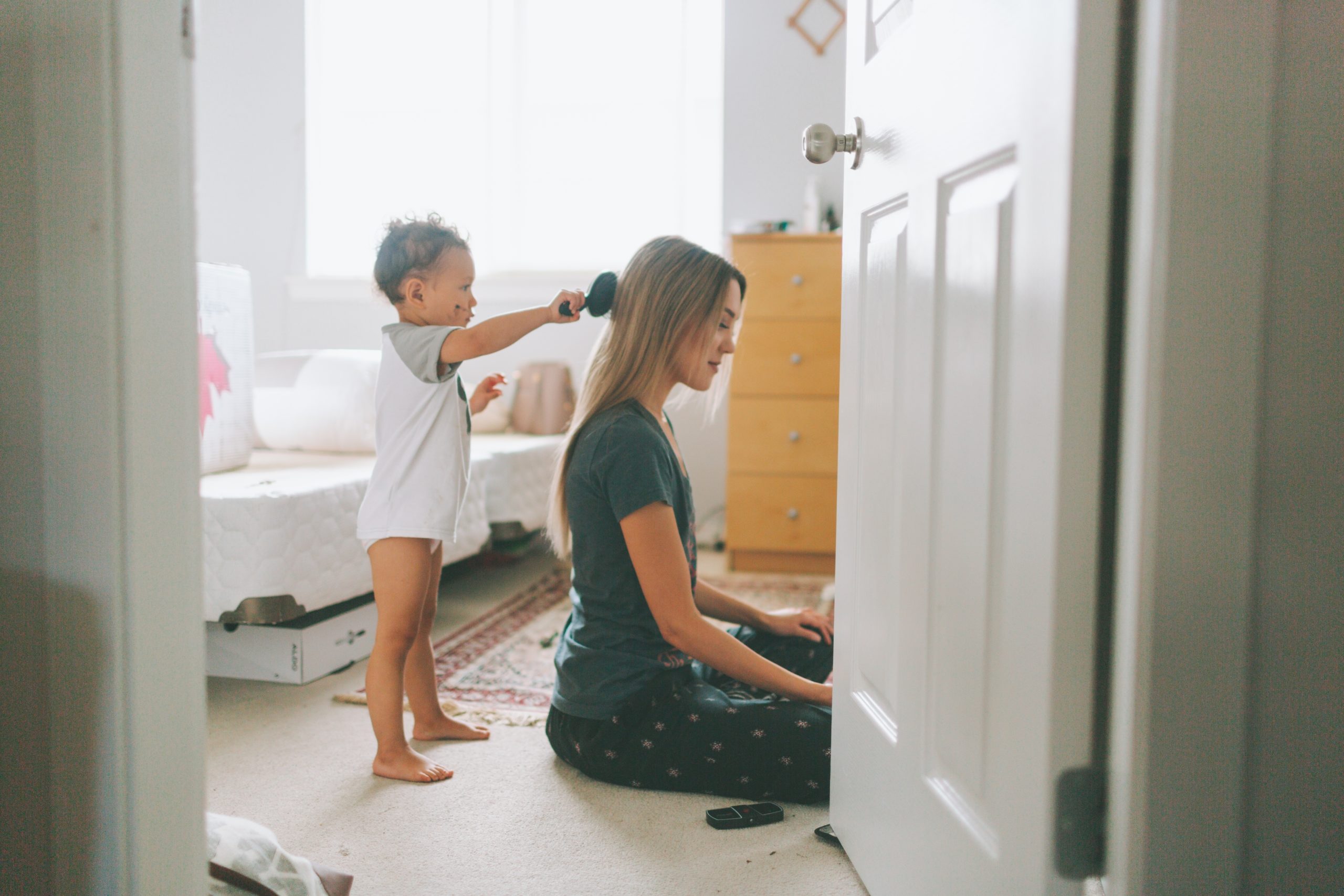 little boy brushing moms hair