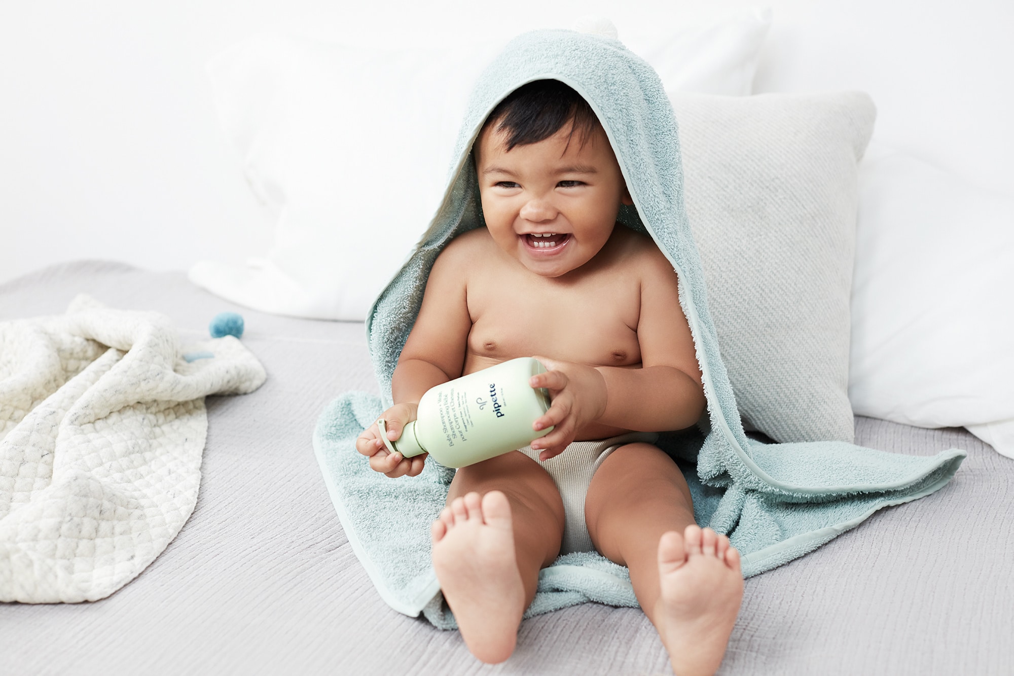 baby sitting outside a bath