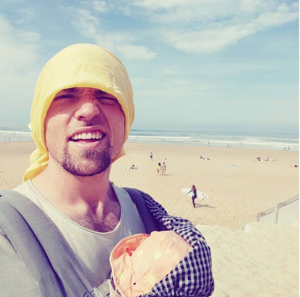 dad holding baby on the beach