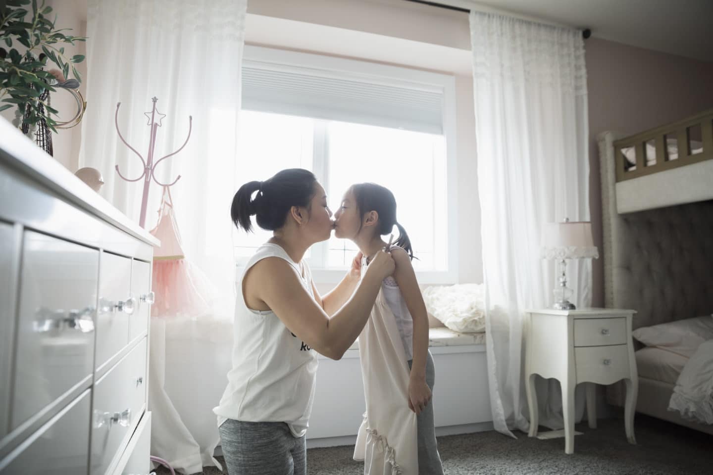 mom and daughter kissing