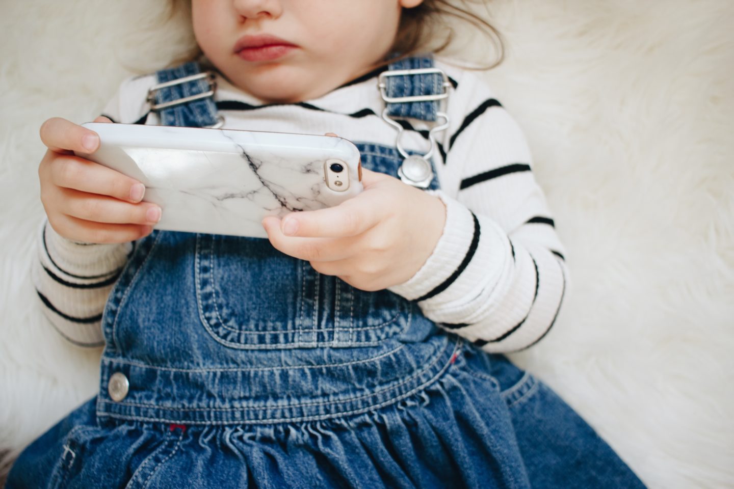 little girl playing with phone