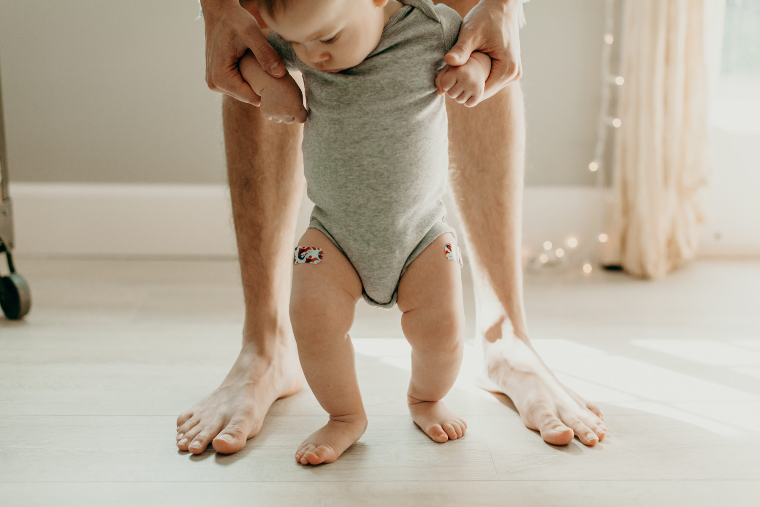 mom helping baby walk