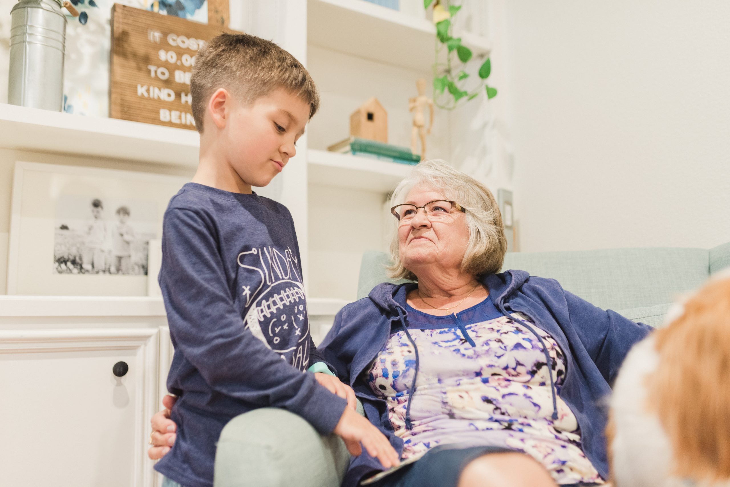 little boy talking to an older woman