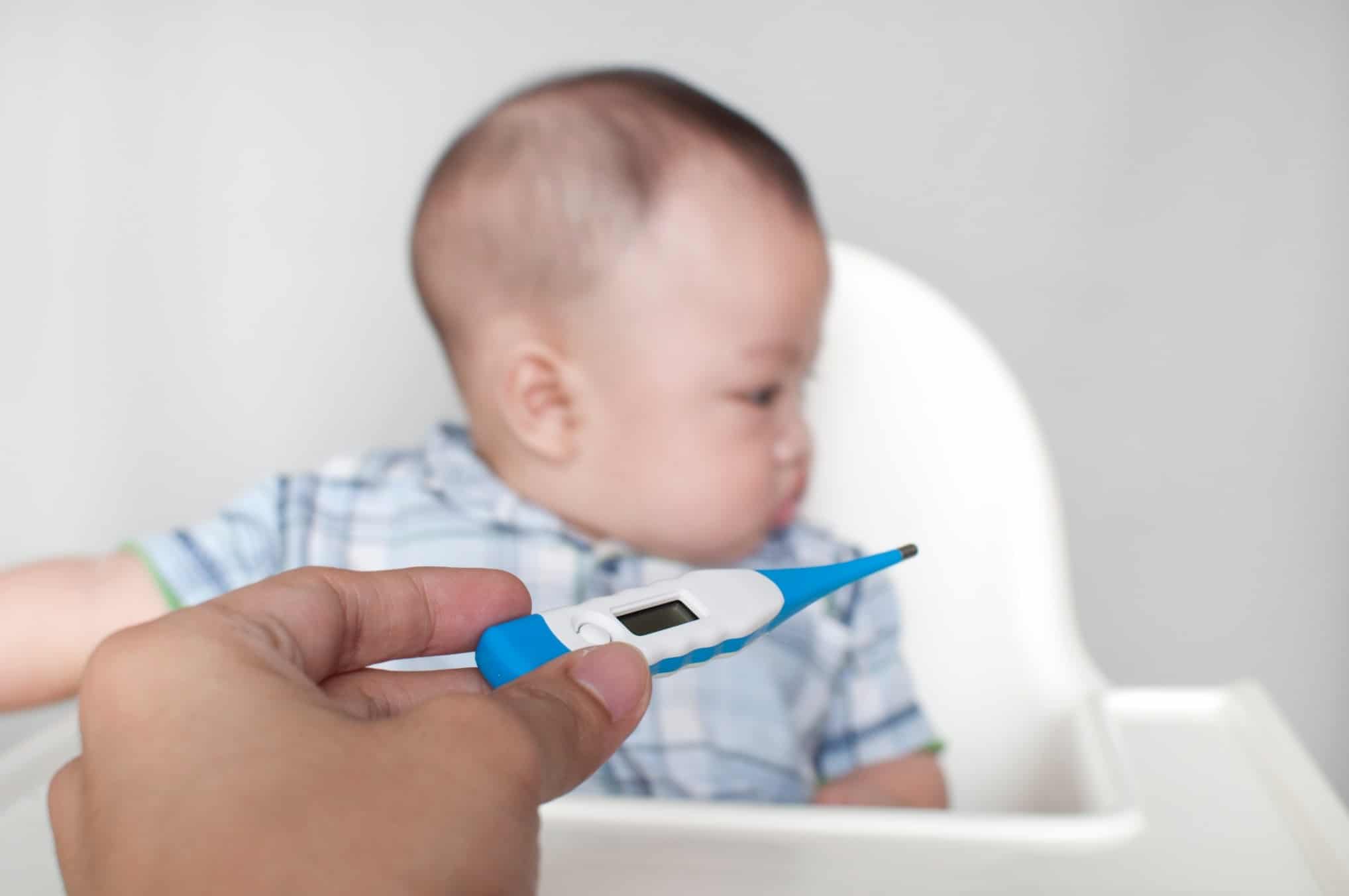 thermometer in front of a baby