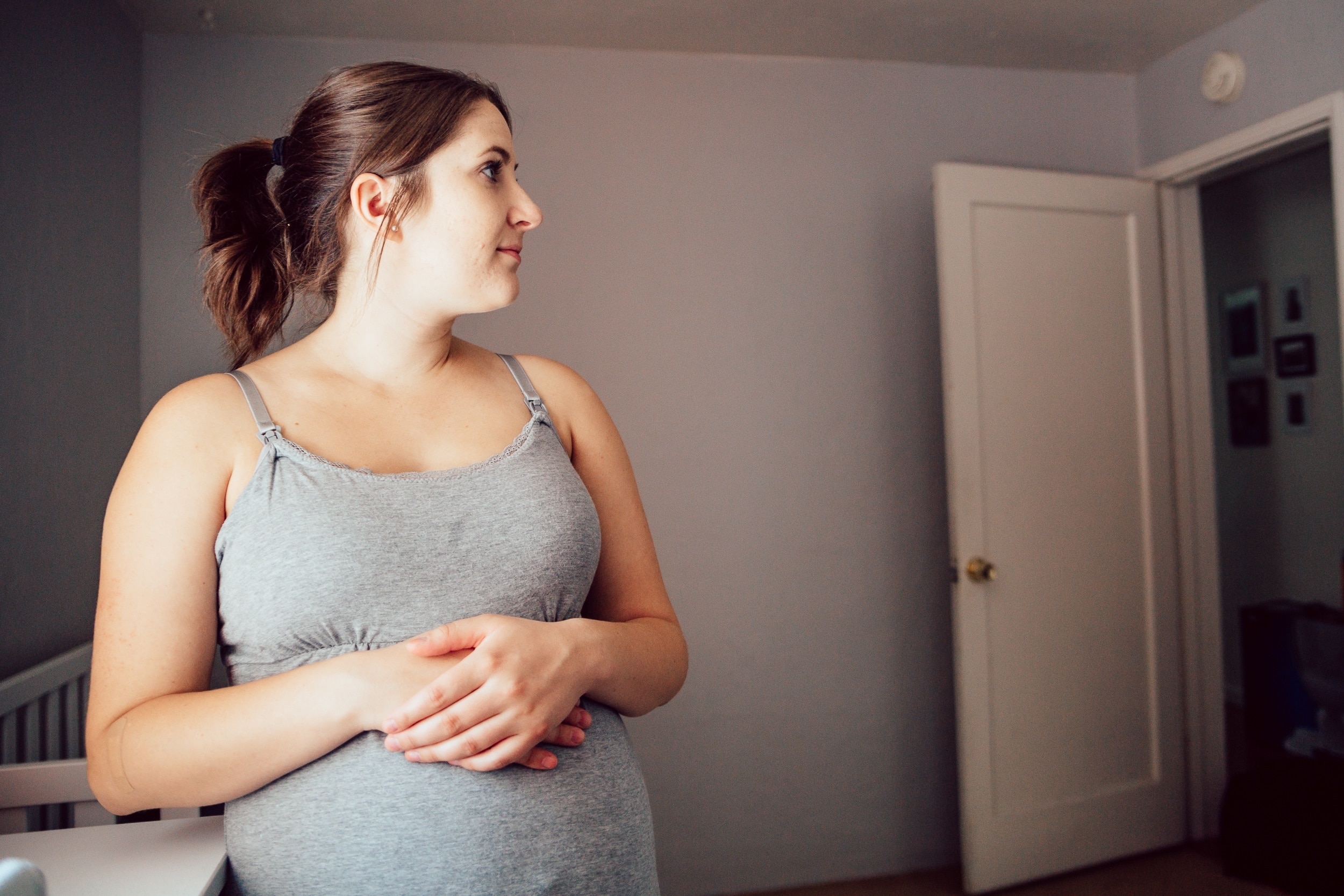 pregnant woman holding belly