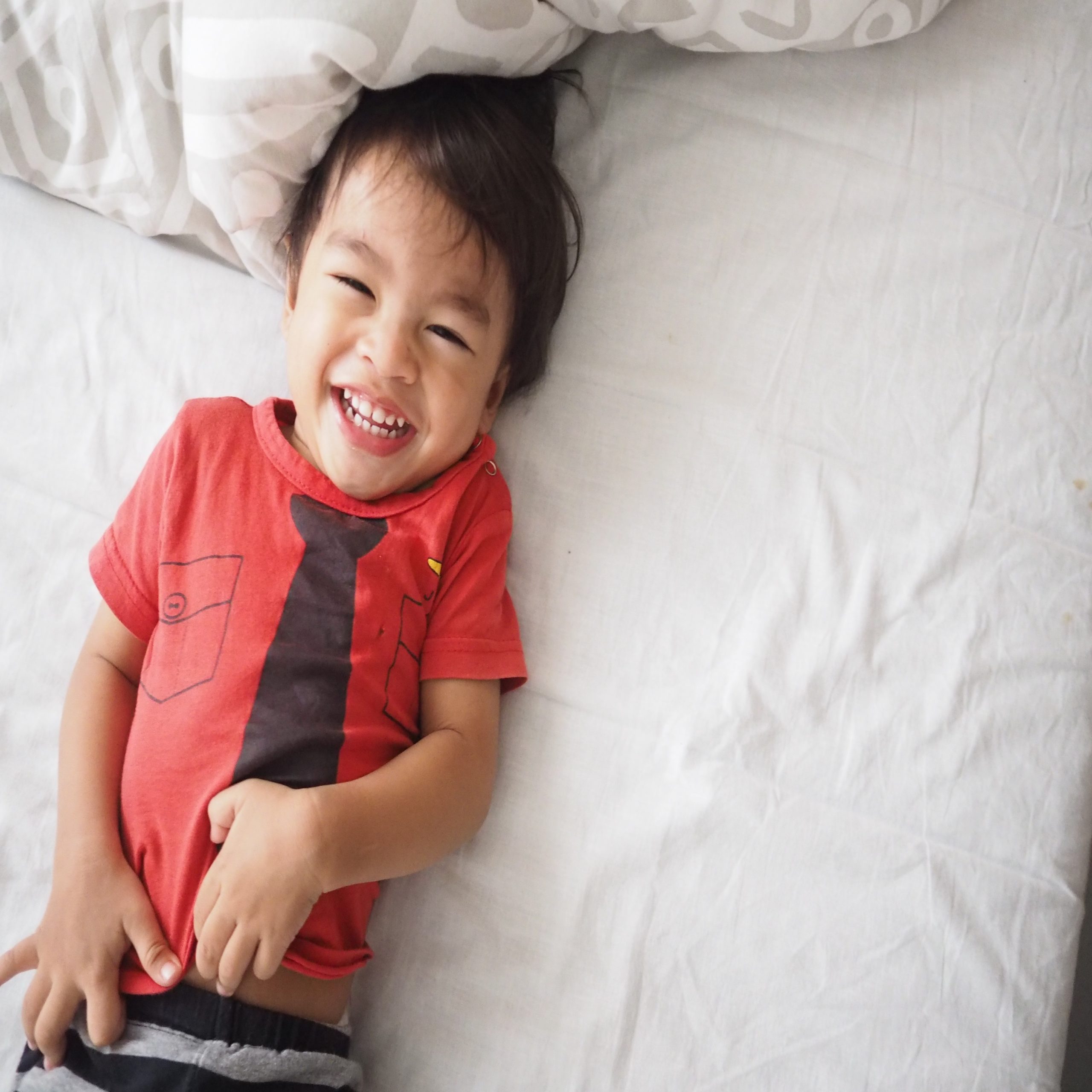 child laughing on the bed