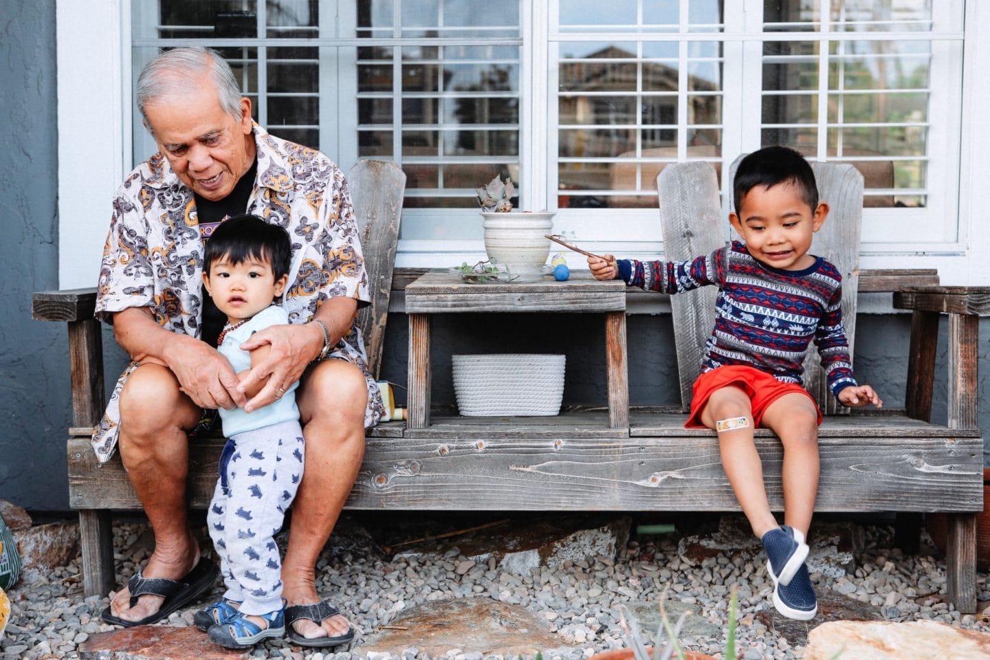 grandpa playing with grandkids on a porch