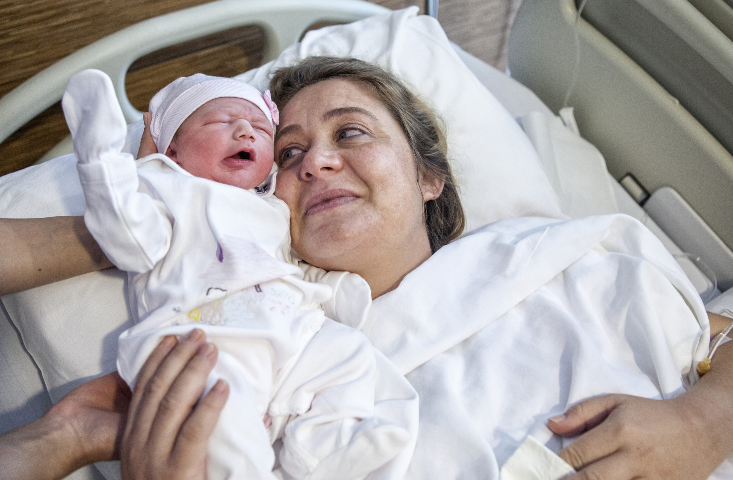 mom holding newborn baby in spite of declining birth rates
