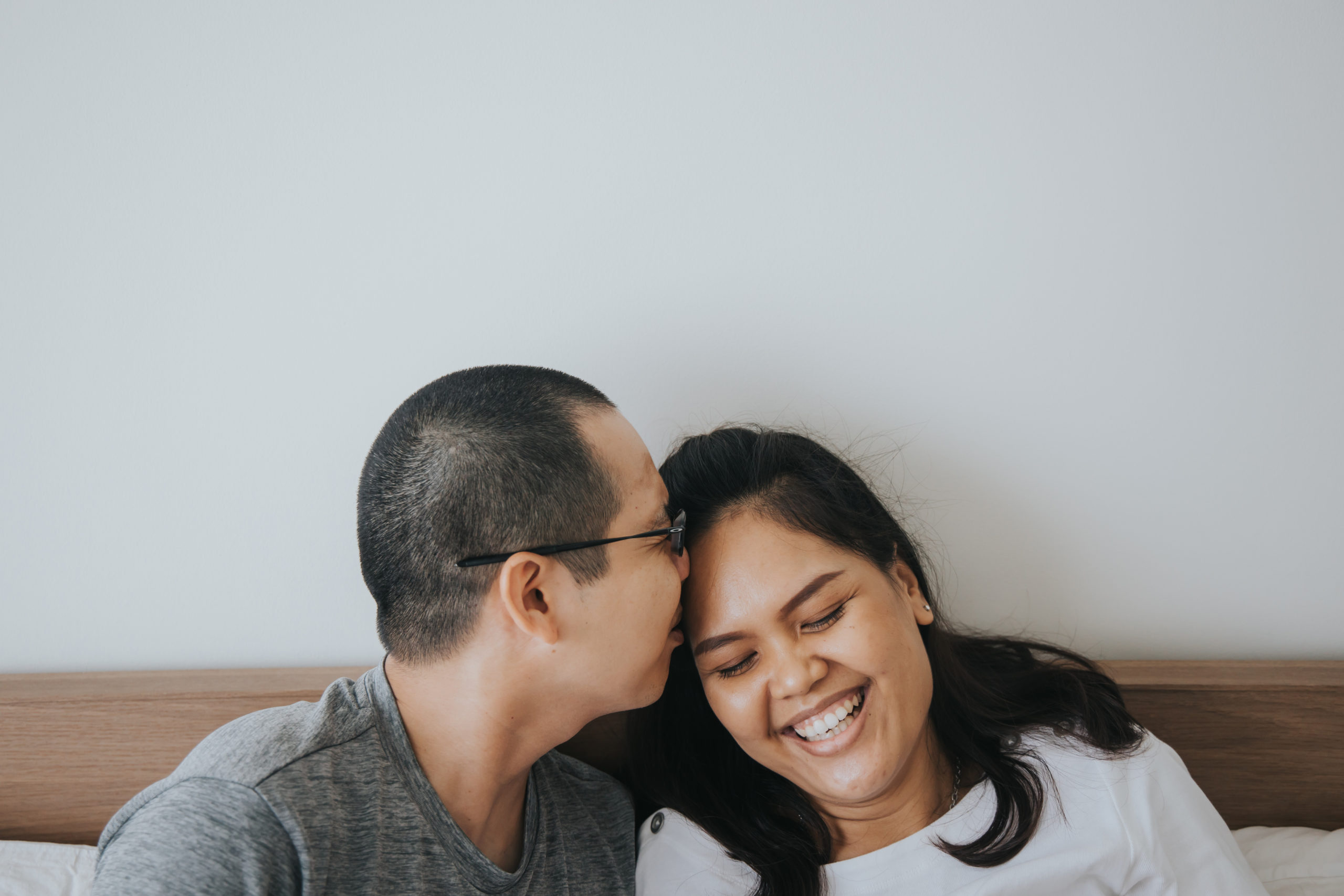 husband kissing wife on the head