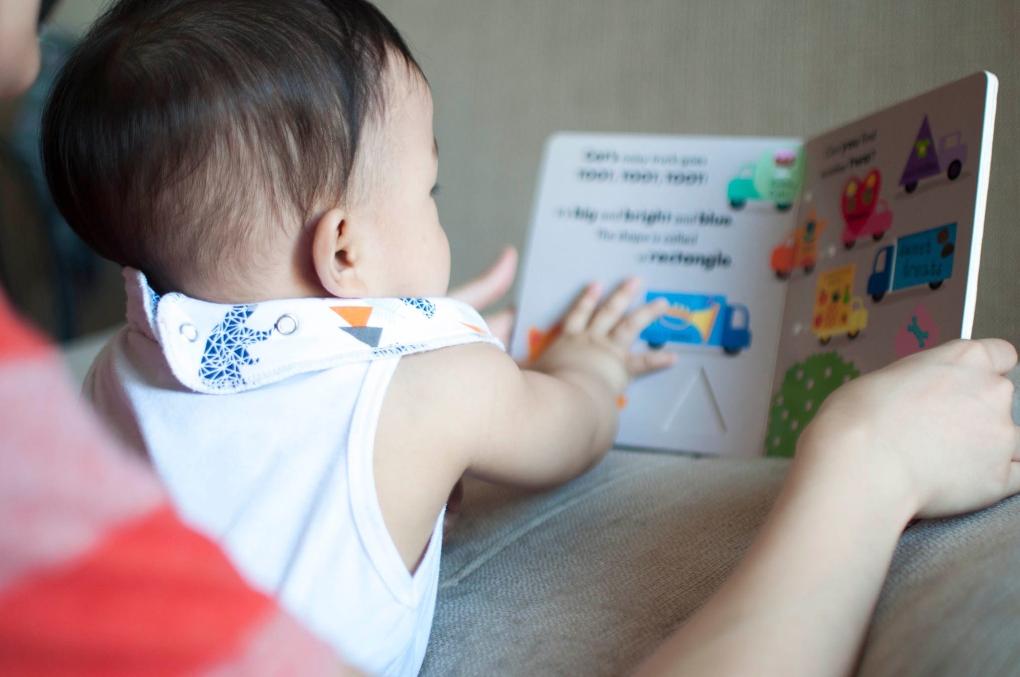 baby playing with a book