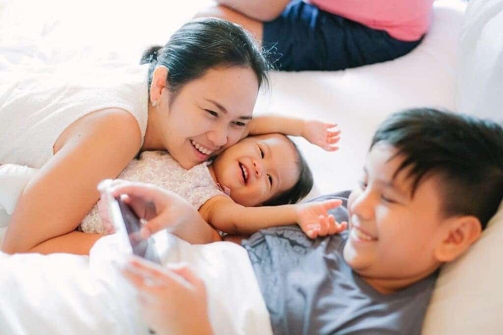 mom smiling with daughter and son- children's 5 love languages