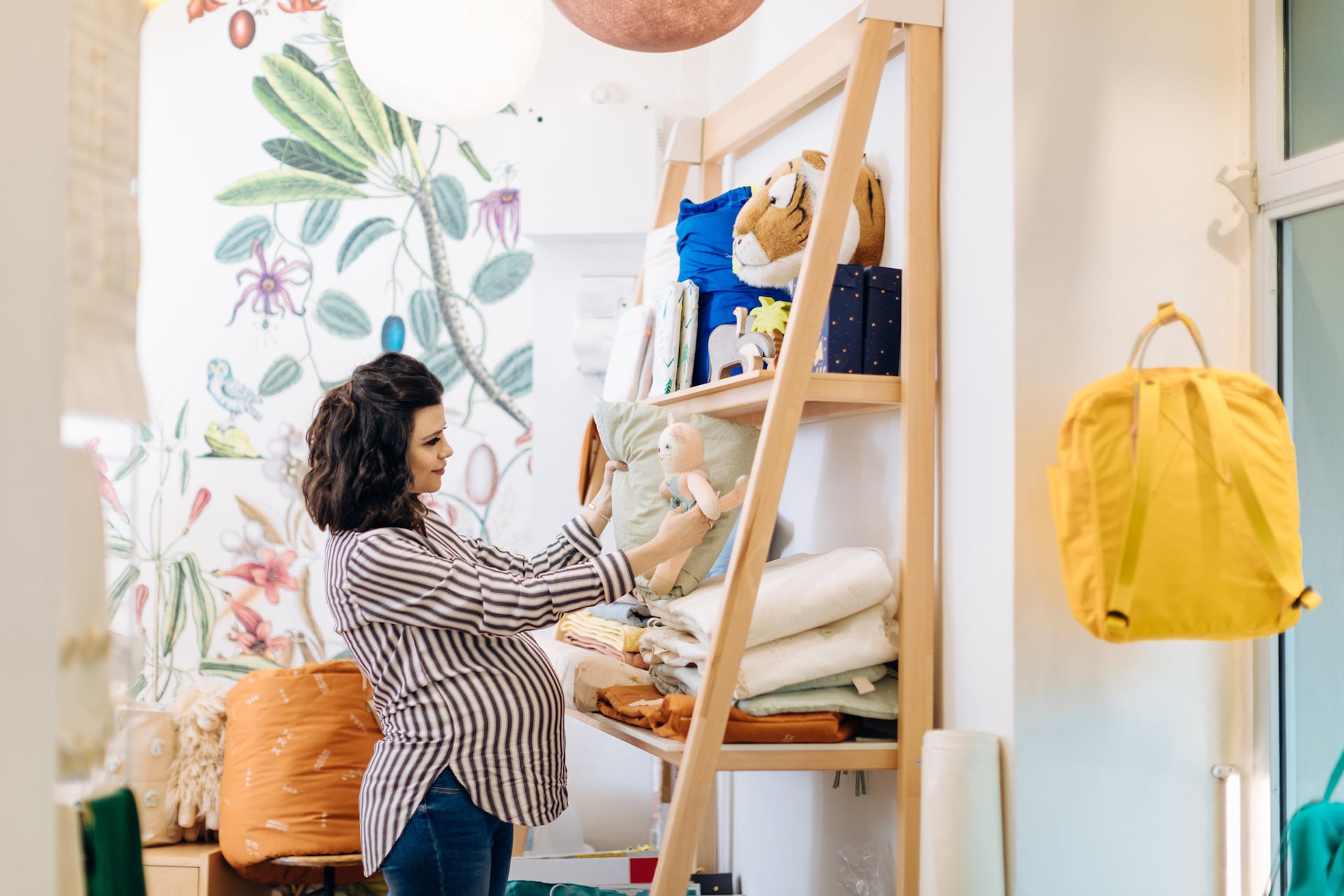 pregnant woman picking out items for her baby registry