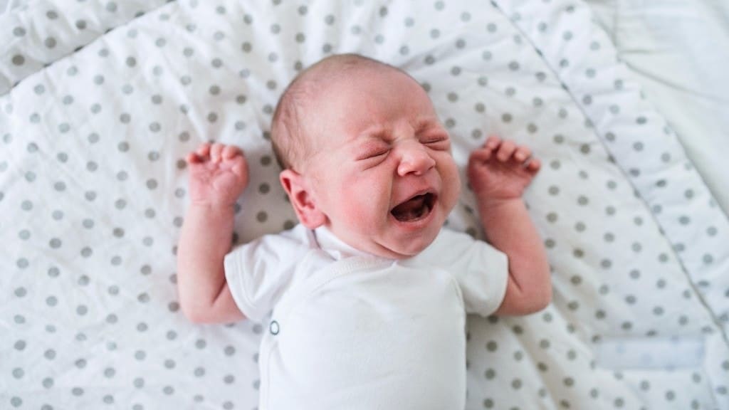 baby crying in a crib