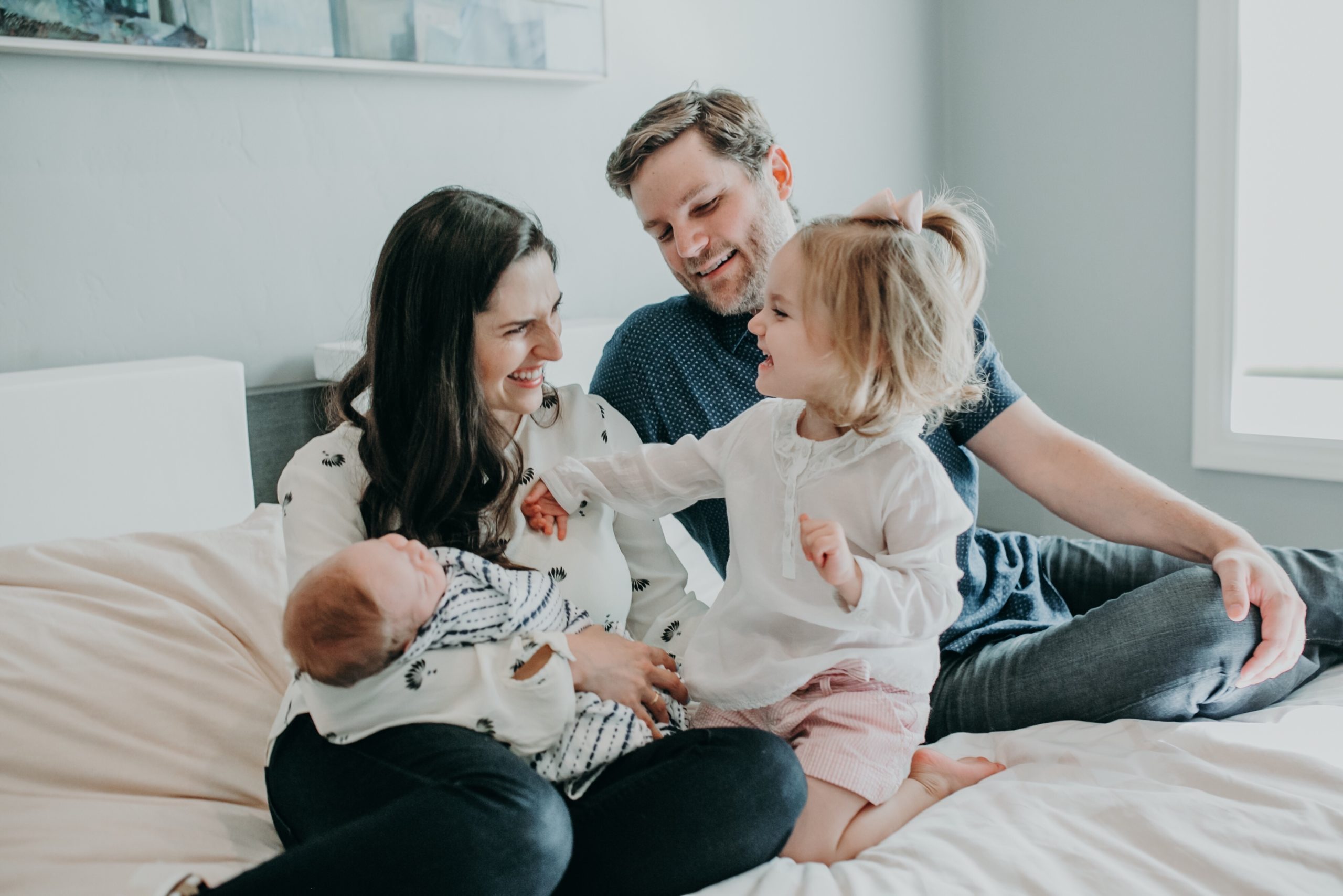 mom and dad holding a baby and a toddler