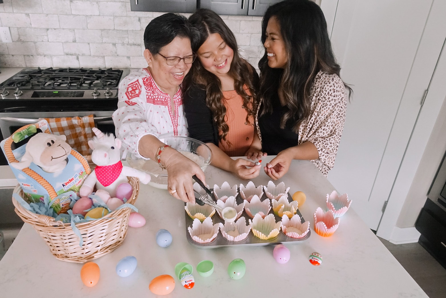 mom decorating easter eggs with kids