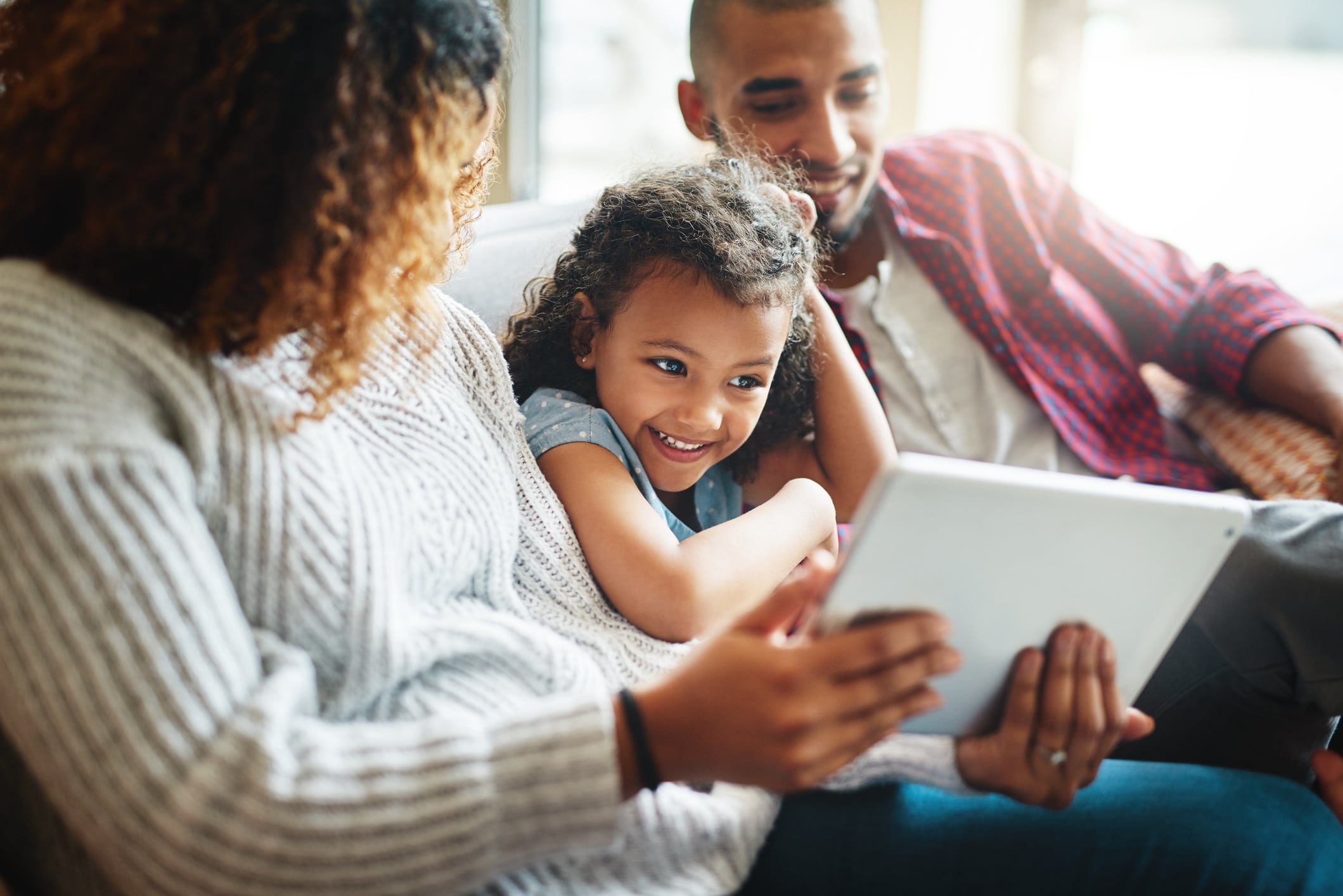 family watching a movie together on an ipad