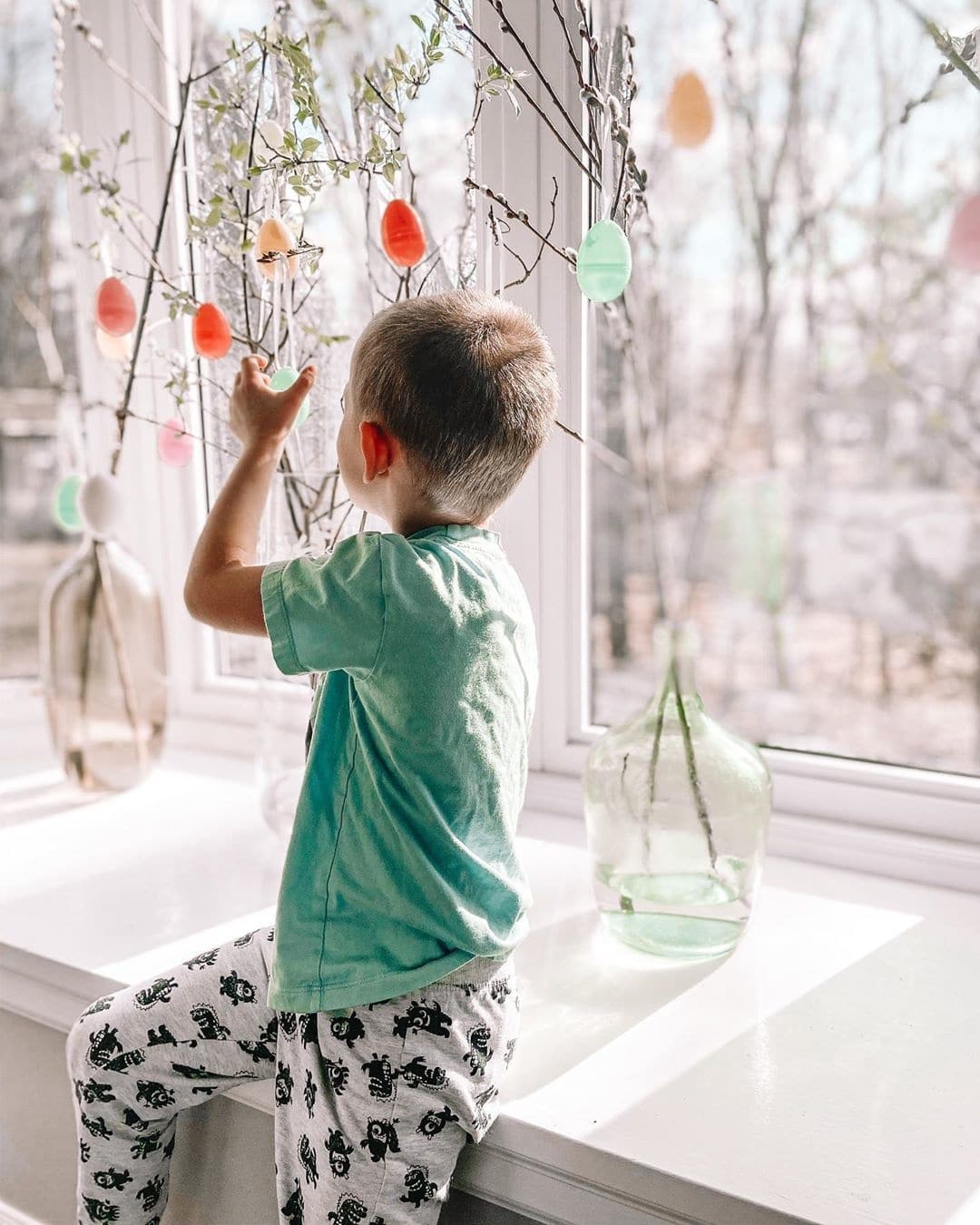 little boy playing with easter trees