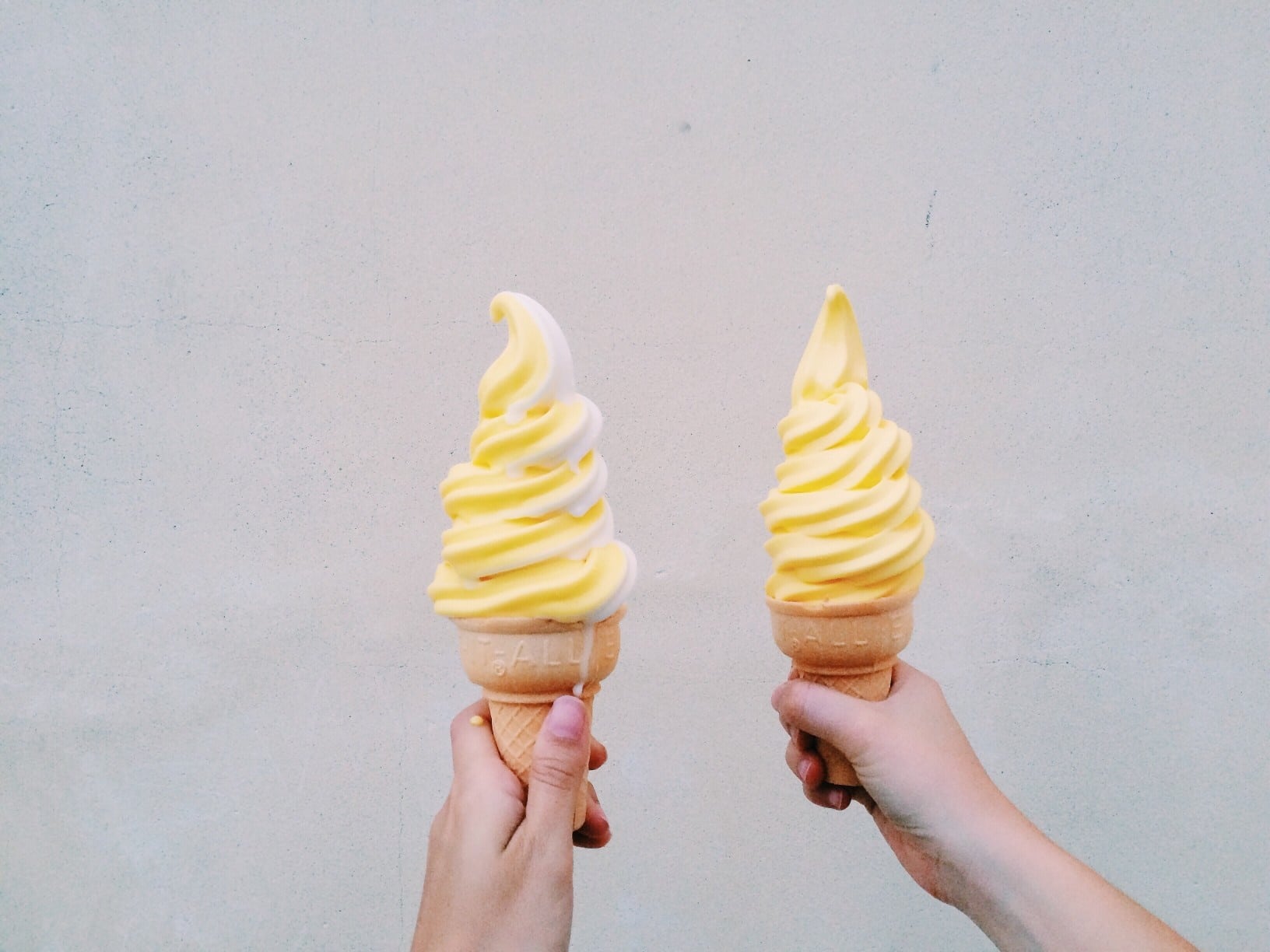 two hands holding dole whip