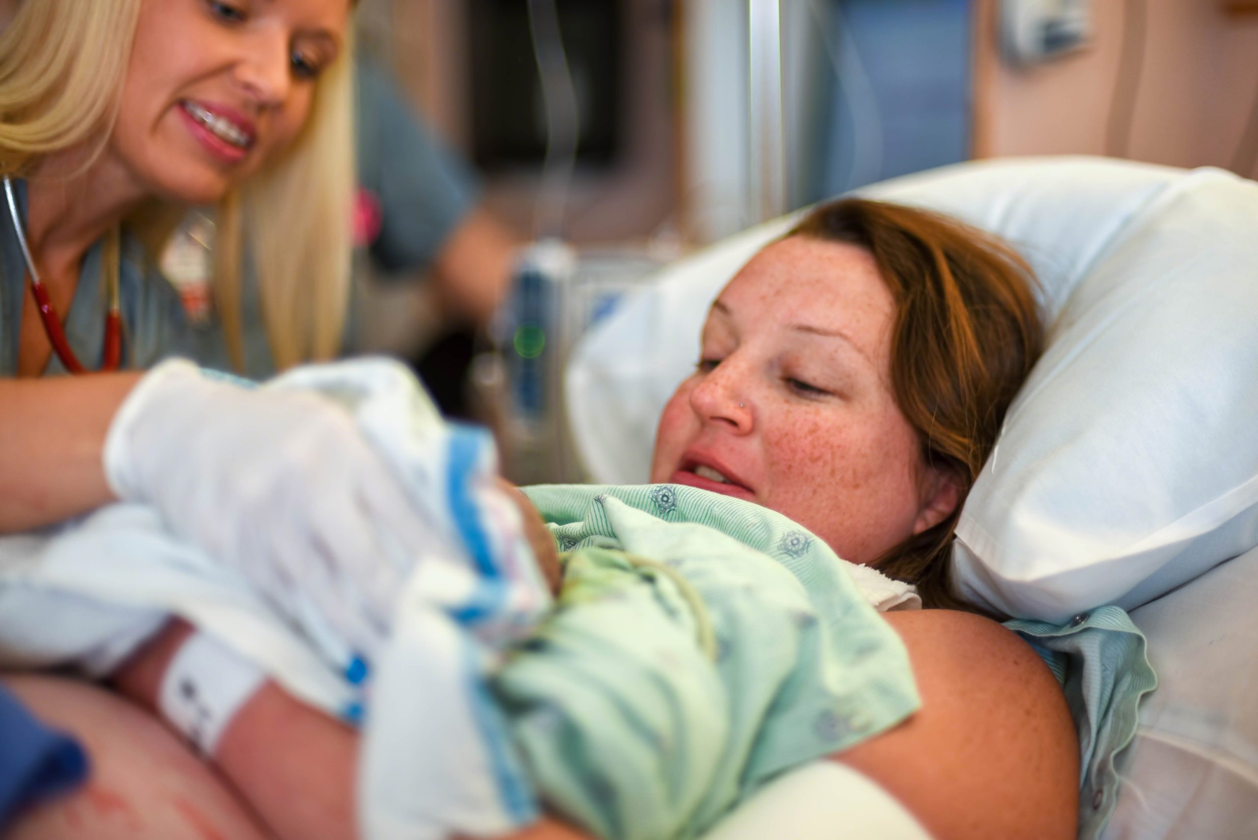 mom holding her new baby in a hospital after giving birth