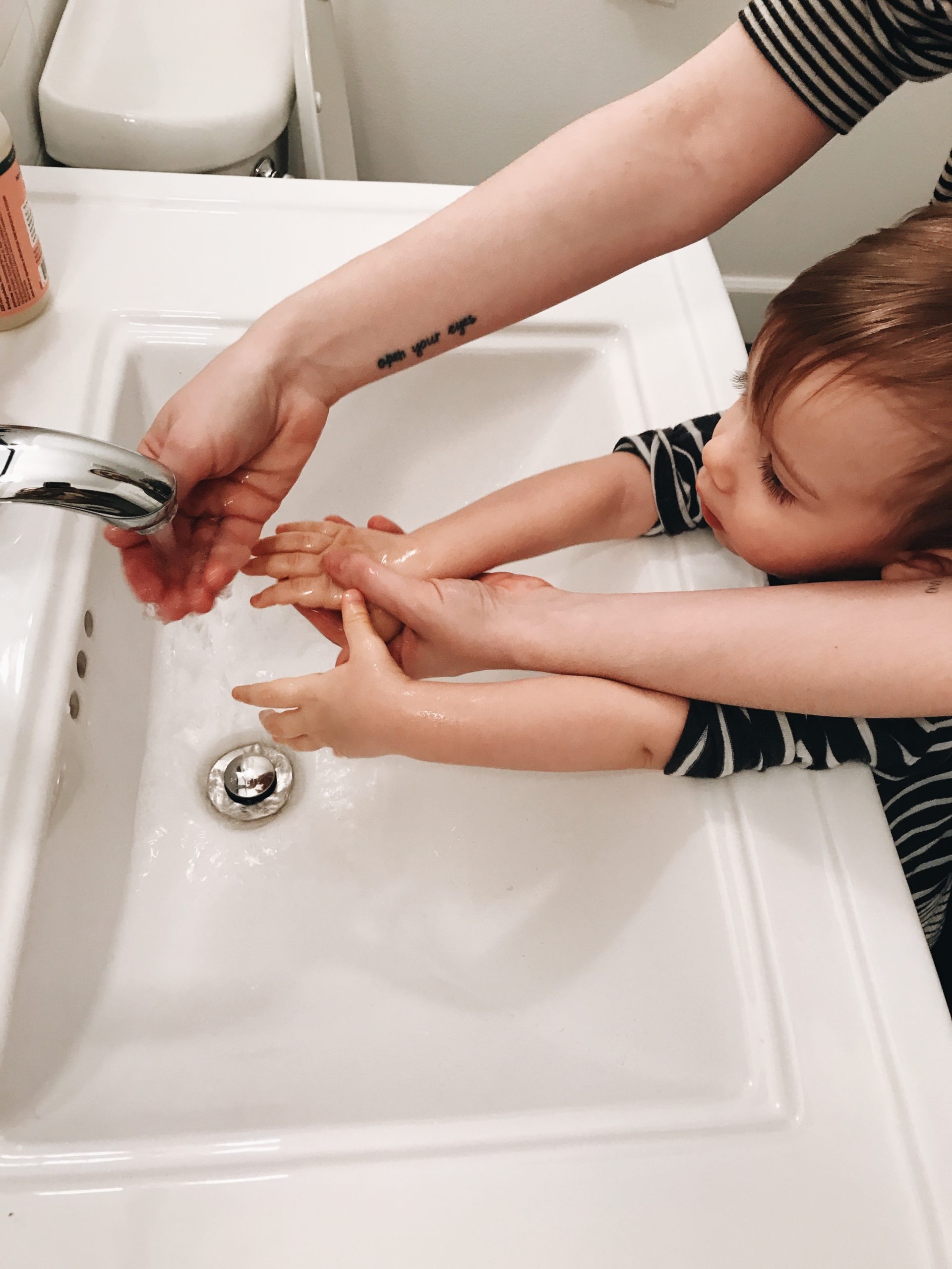 parent washing a child's hands
