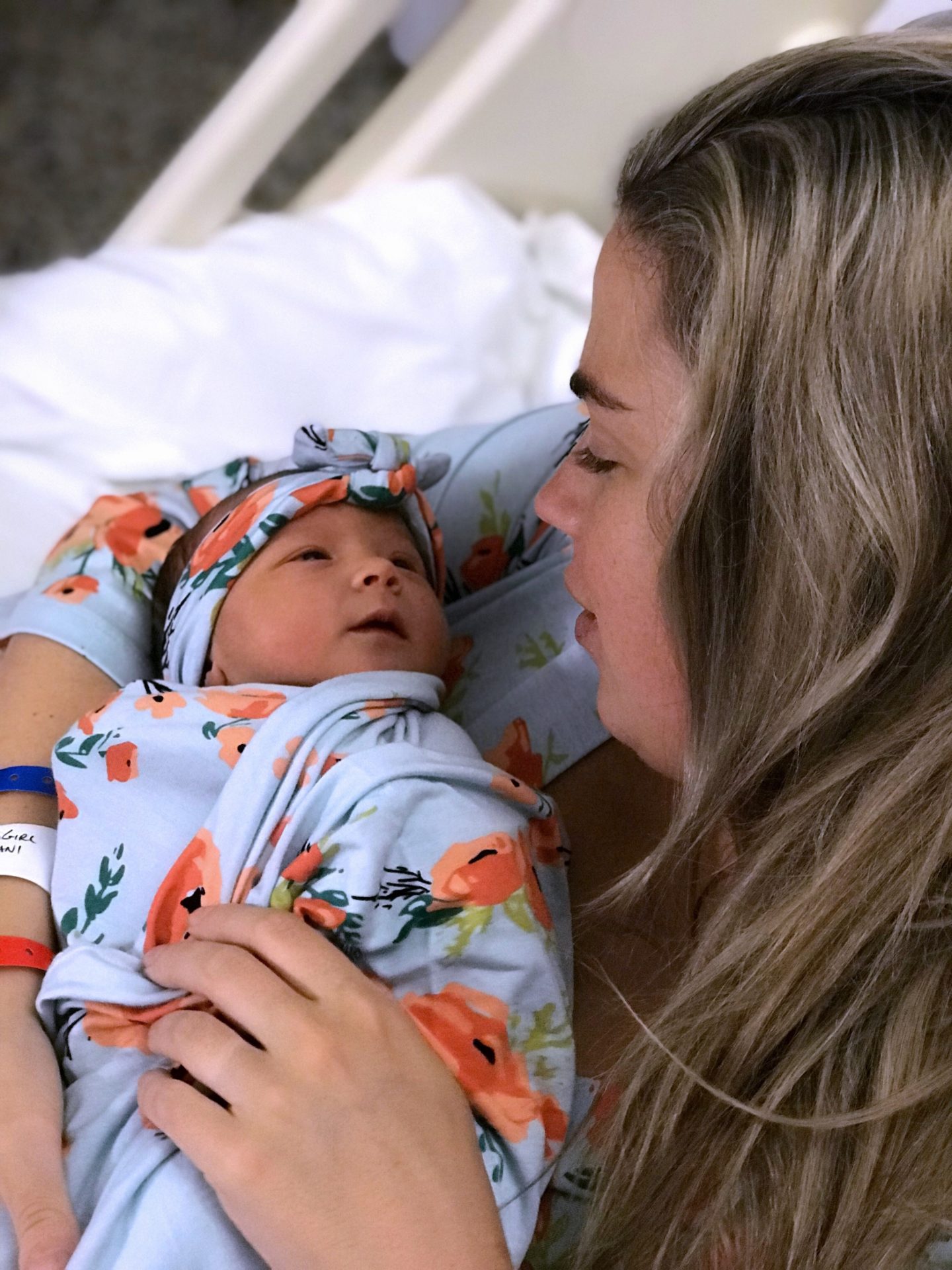 mom looking at newborn baby