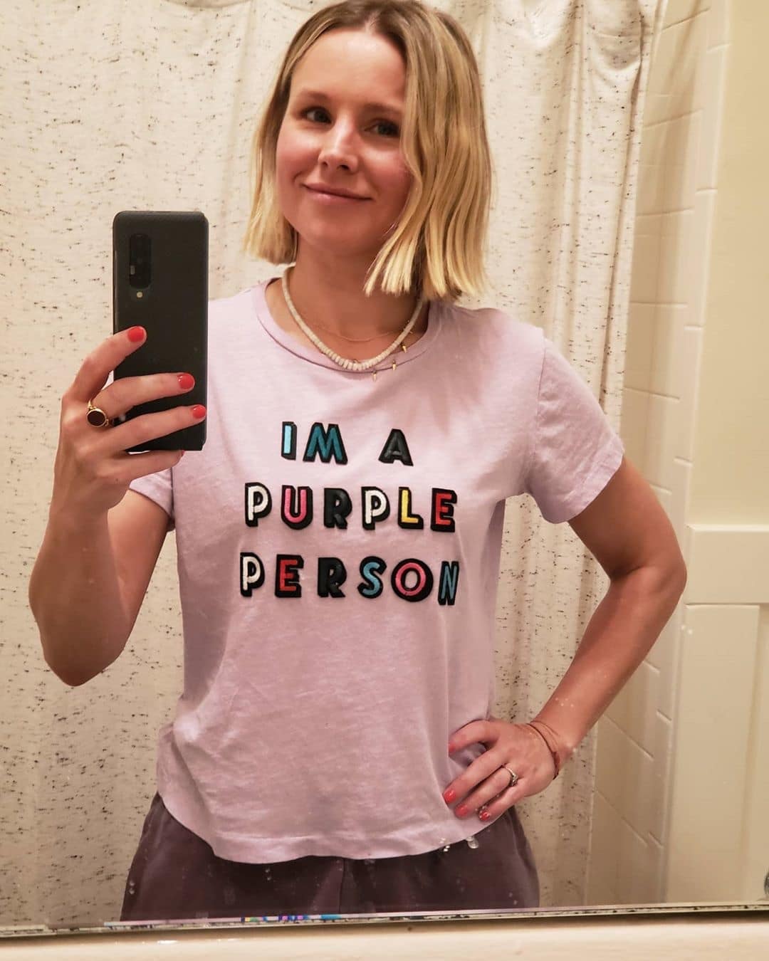 kristen bell taking a selfie in front of a mirror