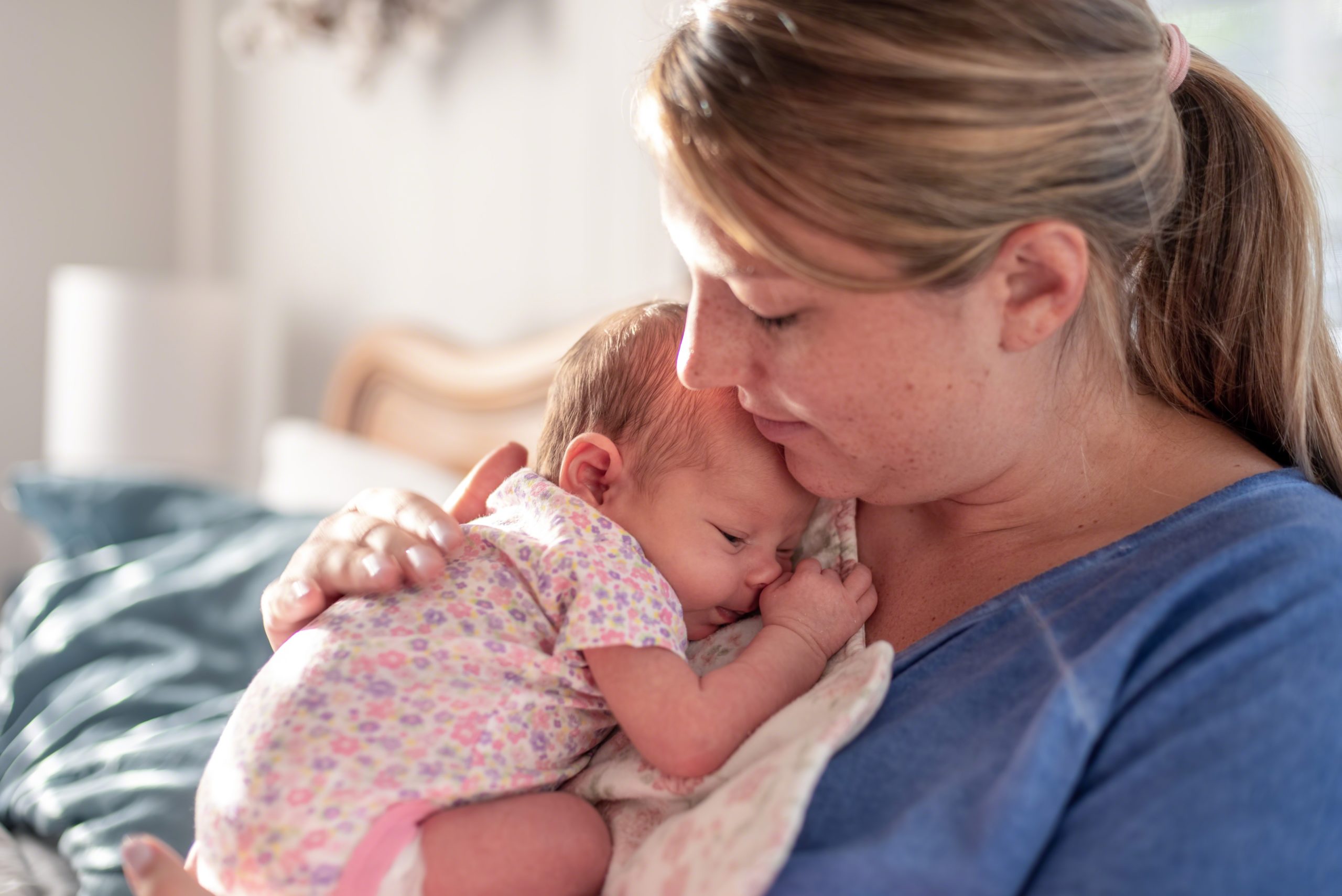 new mom patting newborns back