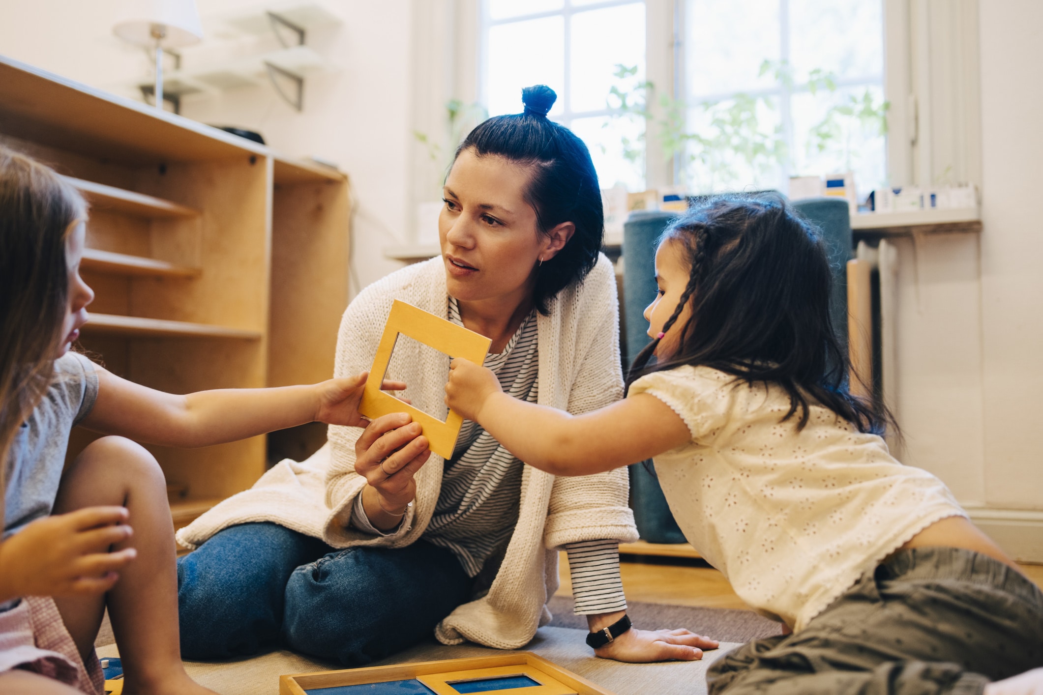 kids playing with teacher at daycare