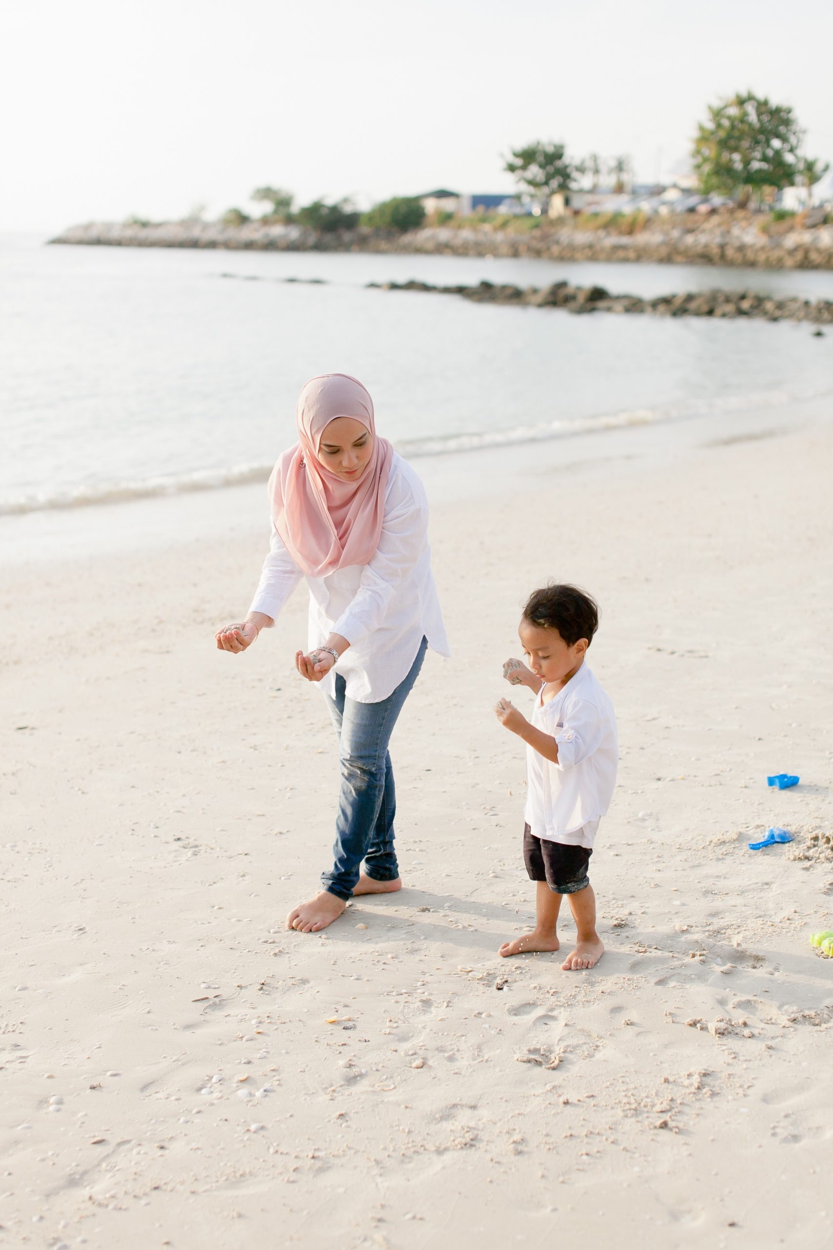 mom and son playing on the beach