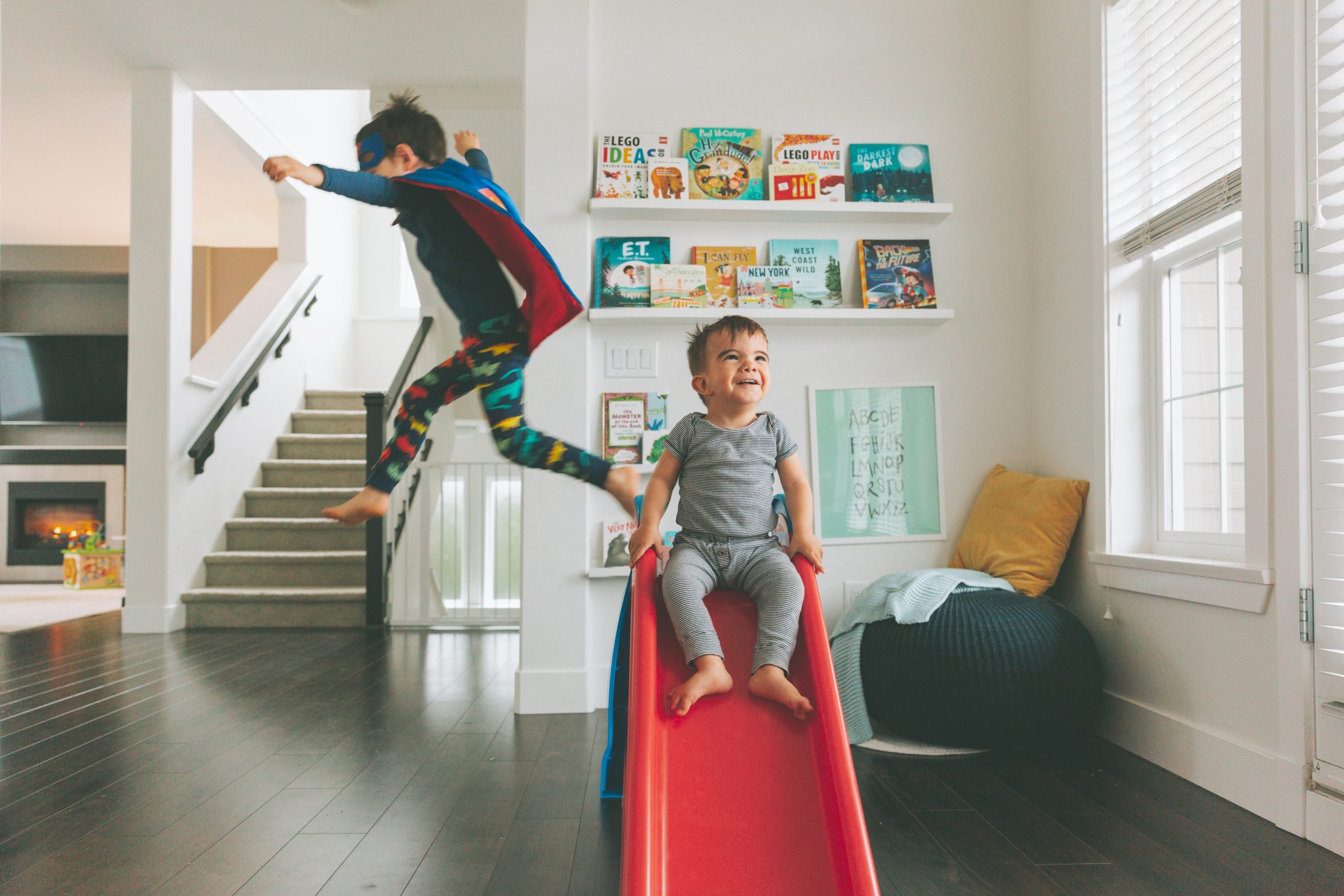 siblings playing on a slide