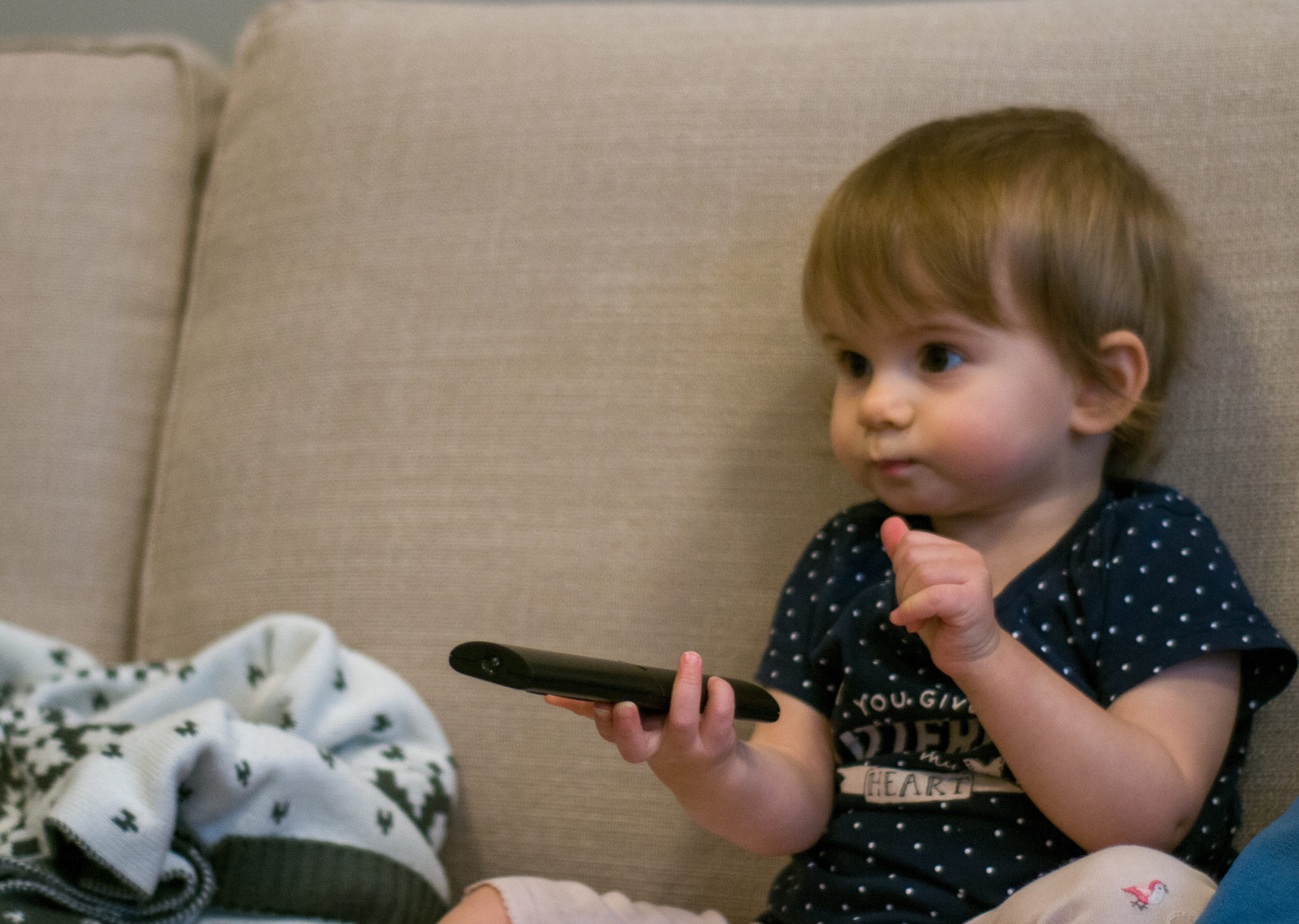 baby boy playing with a remote