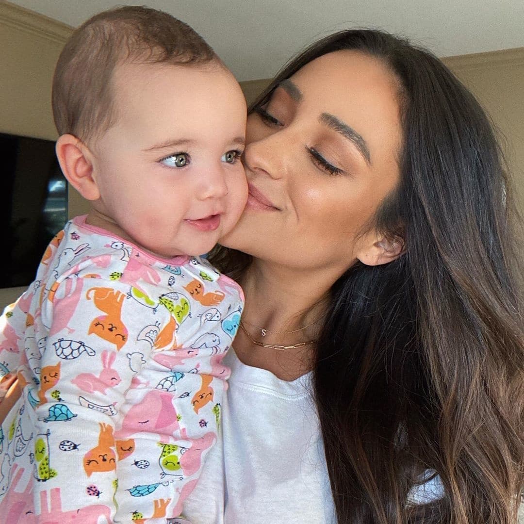 Shay Mitchell kissing daughter on the cheek