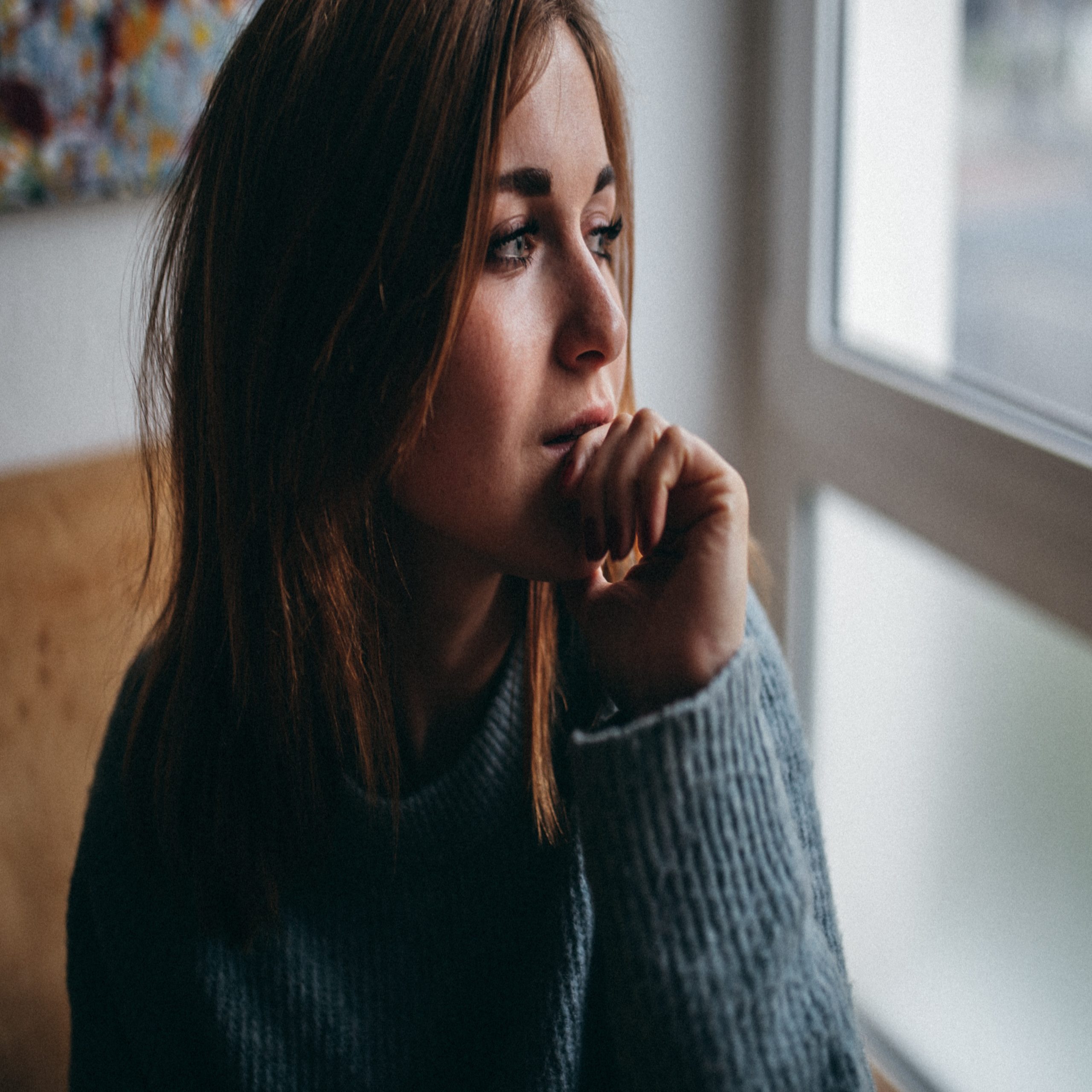 woman looking out window