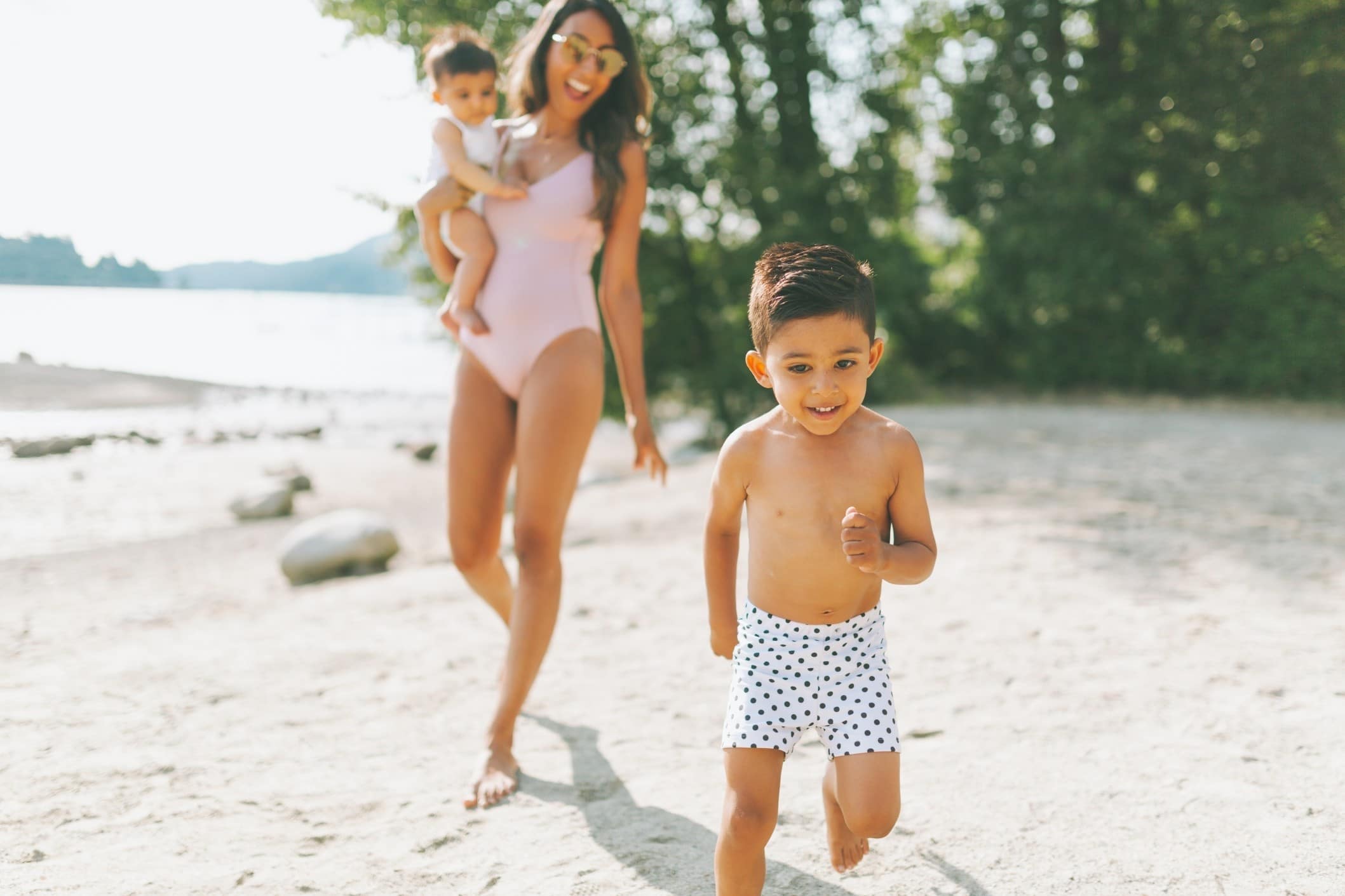 mom on a beach with two kids